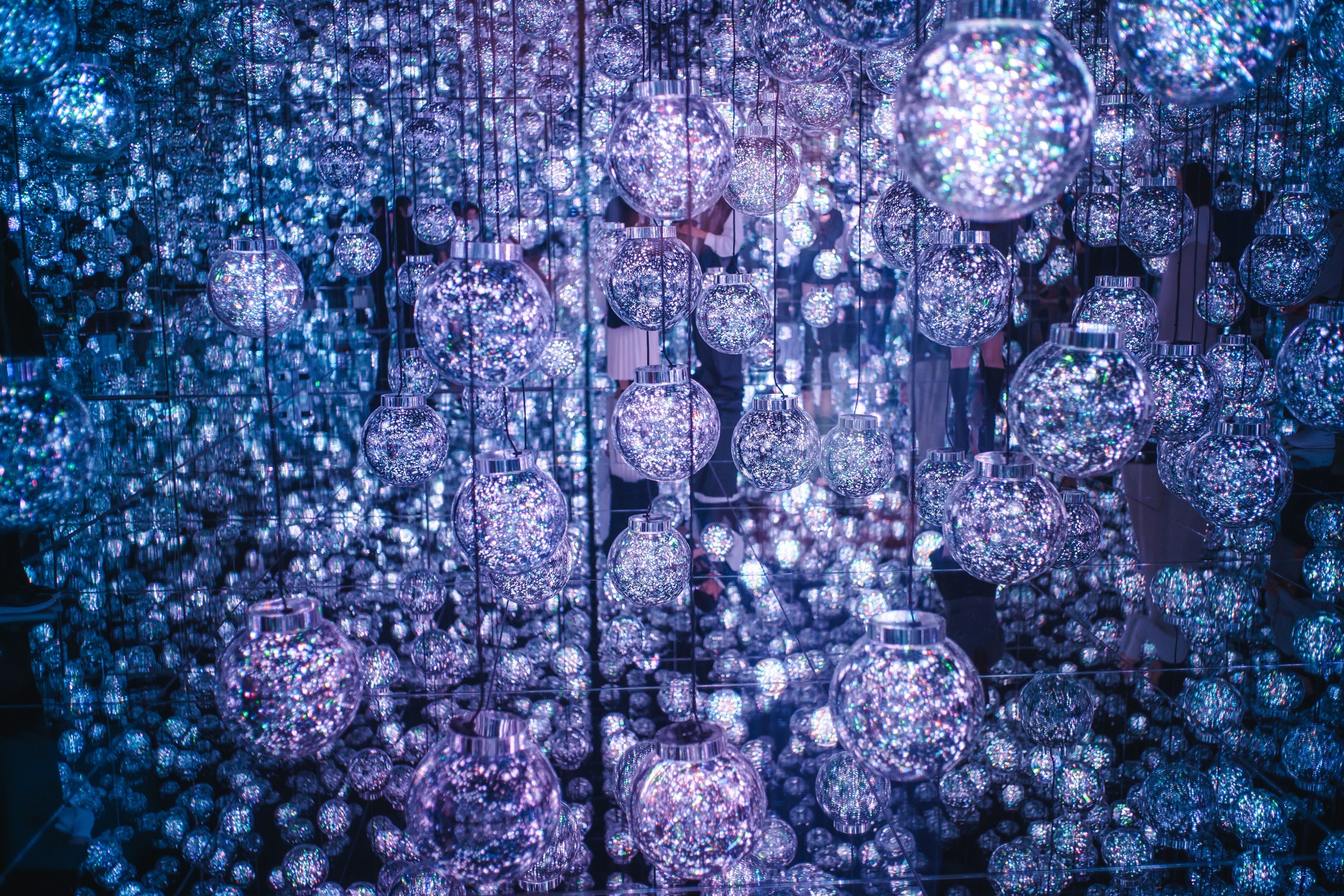 A mesmerizing space filled with spherical decorations illuminated by purple lights