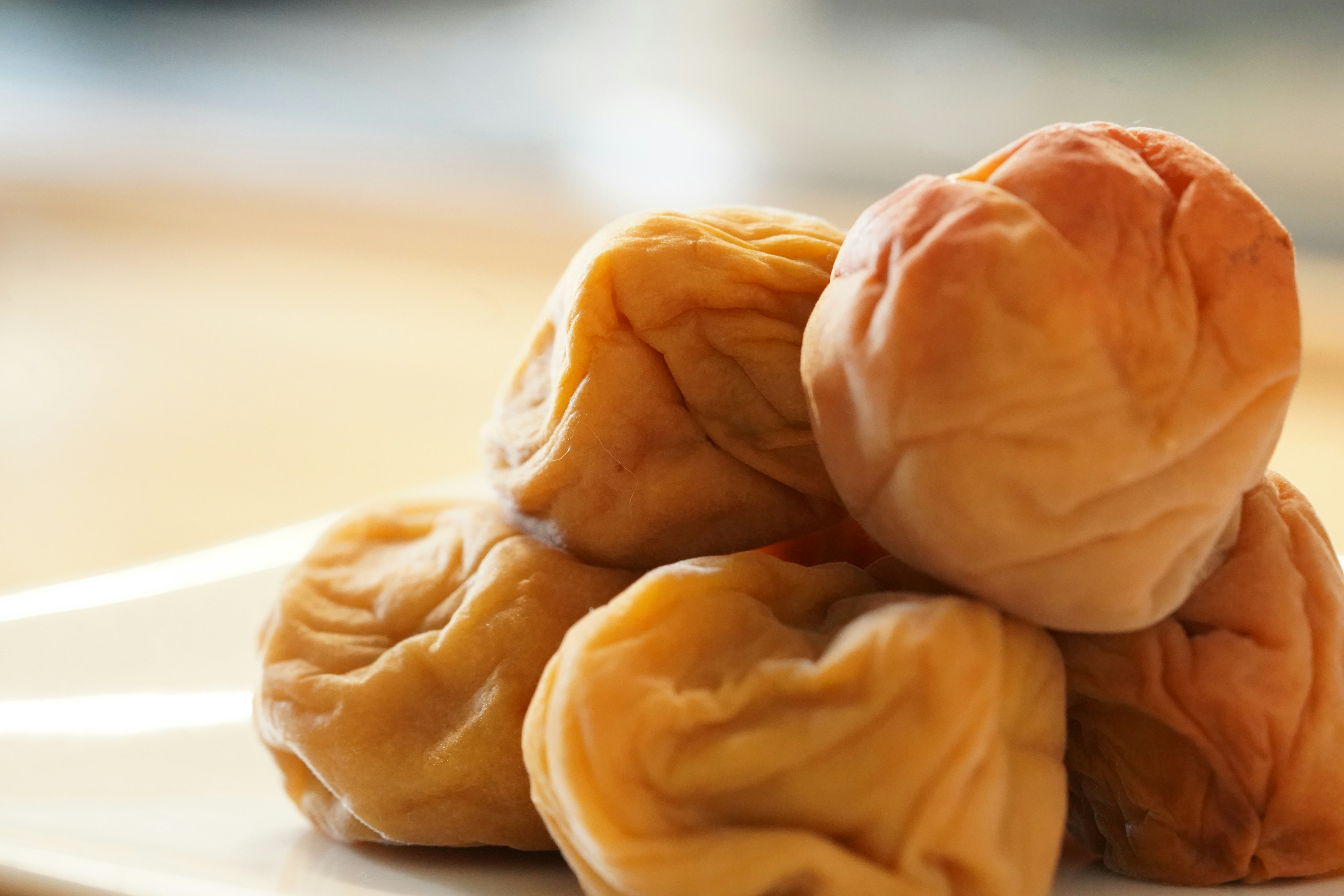 Round clusters of dried plums stacked on a plate