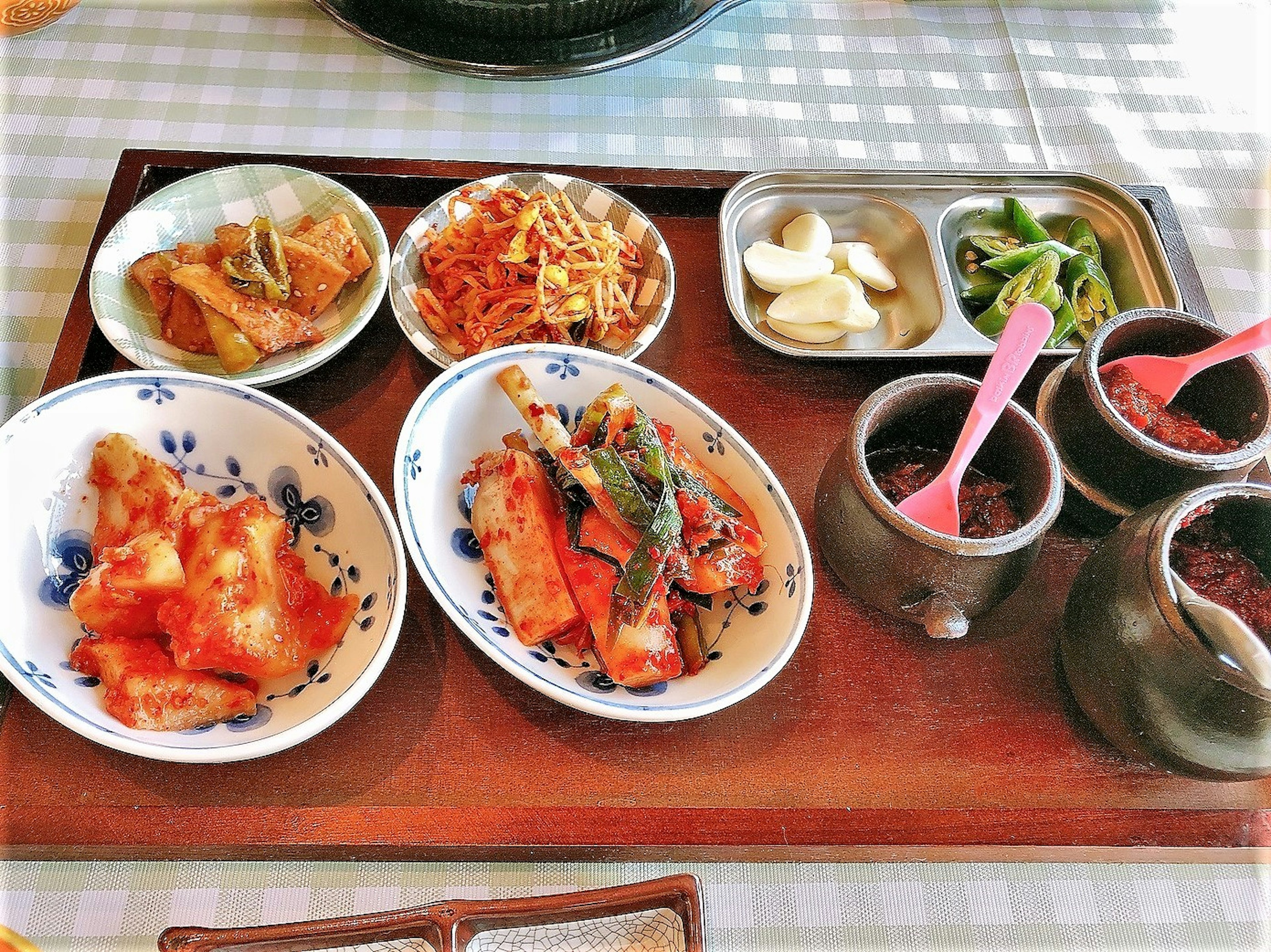 A tray of assorted colorful Korean dishes