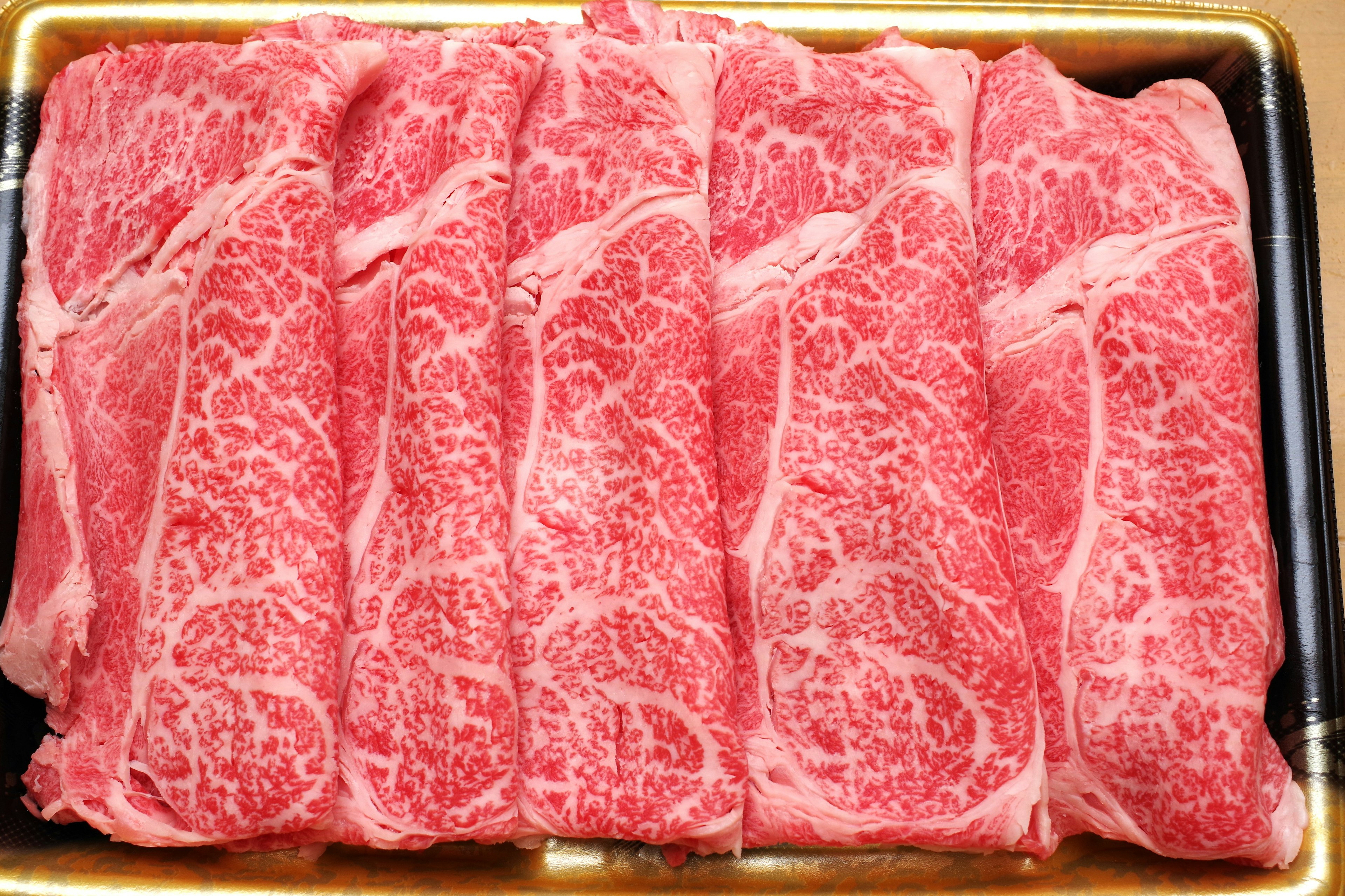 Beautifully marbled slices of beef arranged neatly