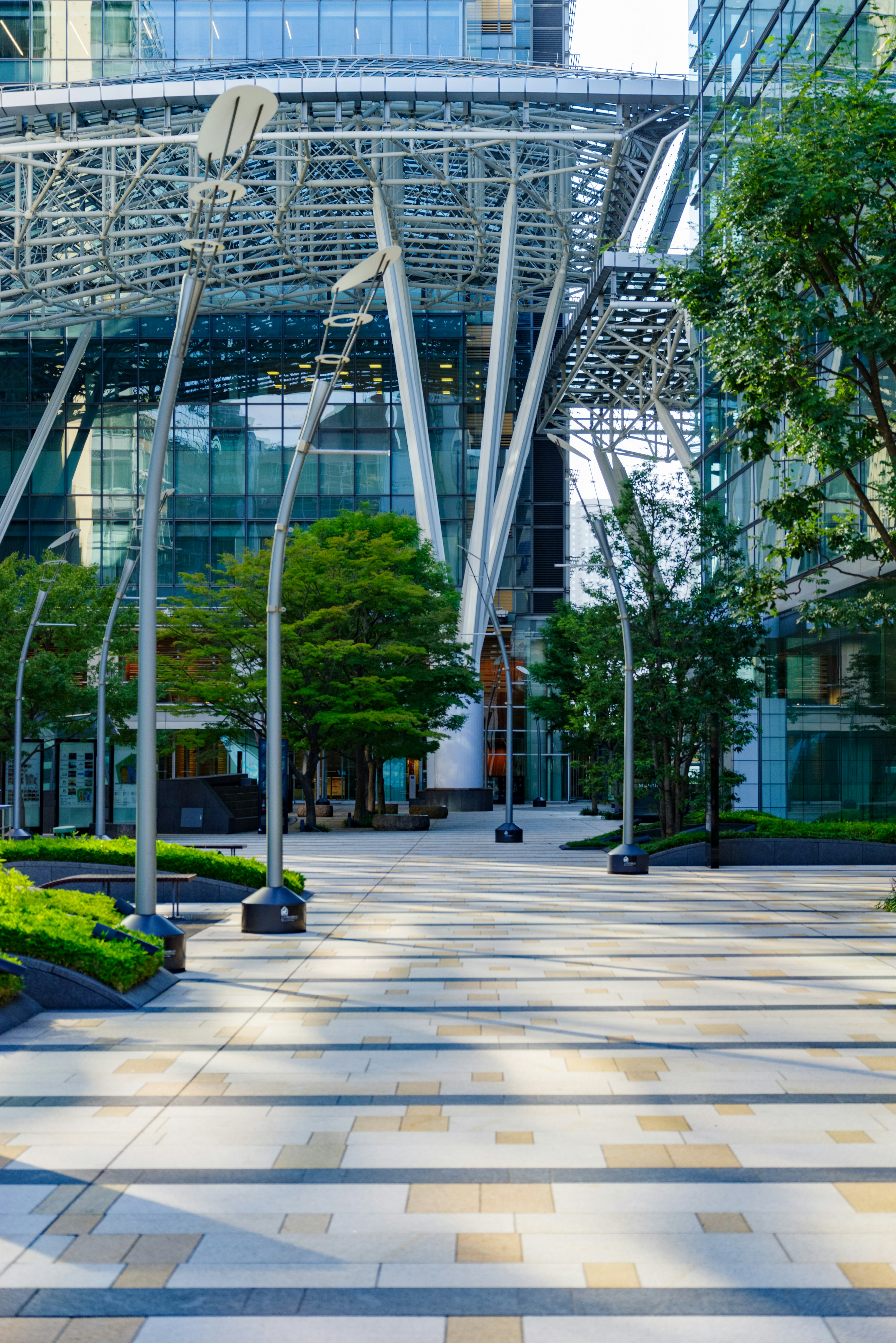 Urban plaza featuring modern architecture and lush greenery