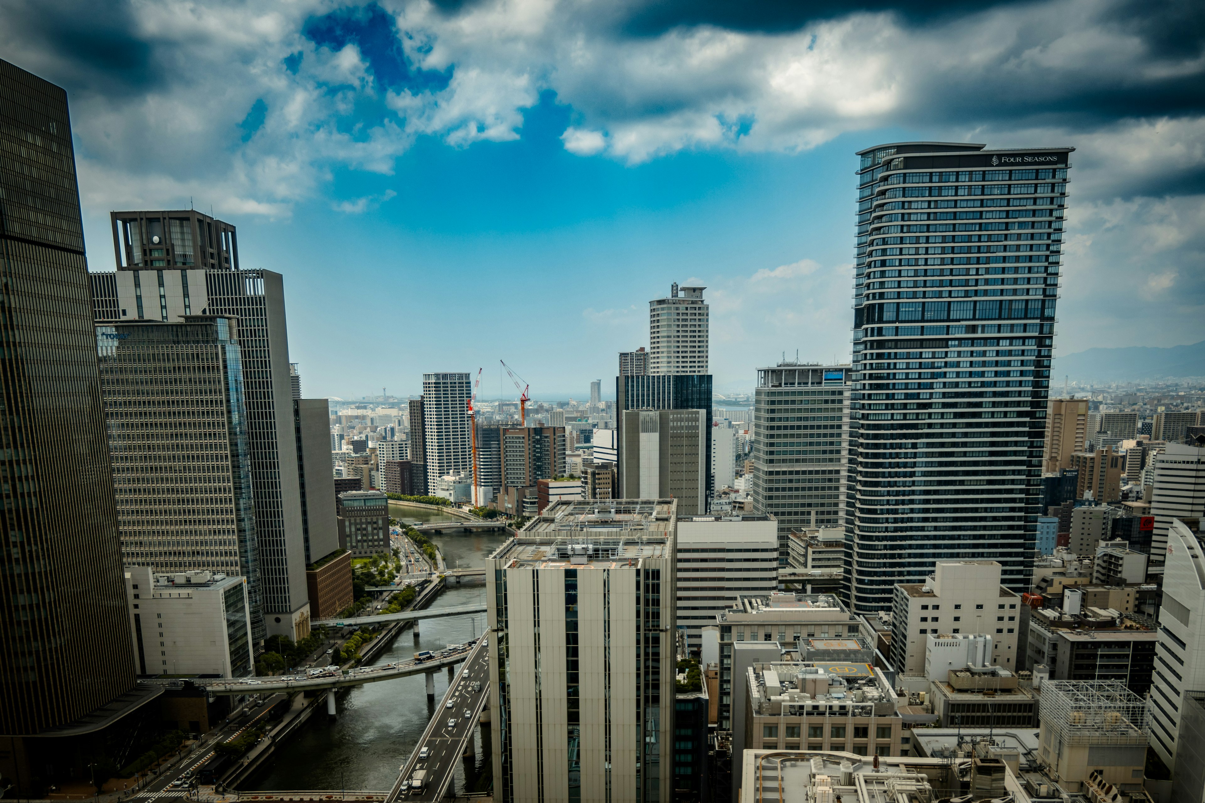 City skyline featuring tall buildings and a blue sky