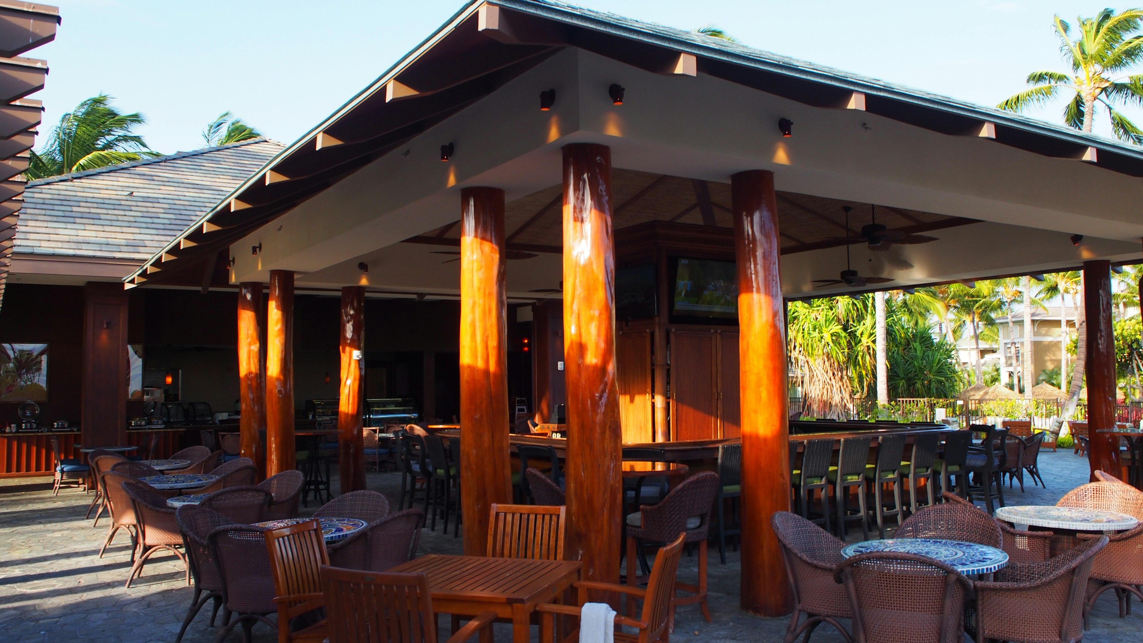 Outdoor restaurant terrace with wooden tables and chairs