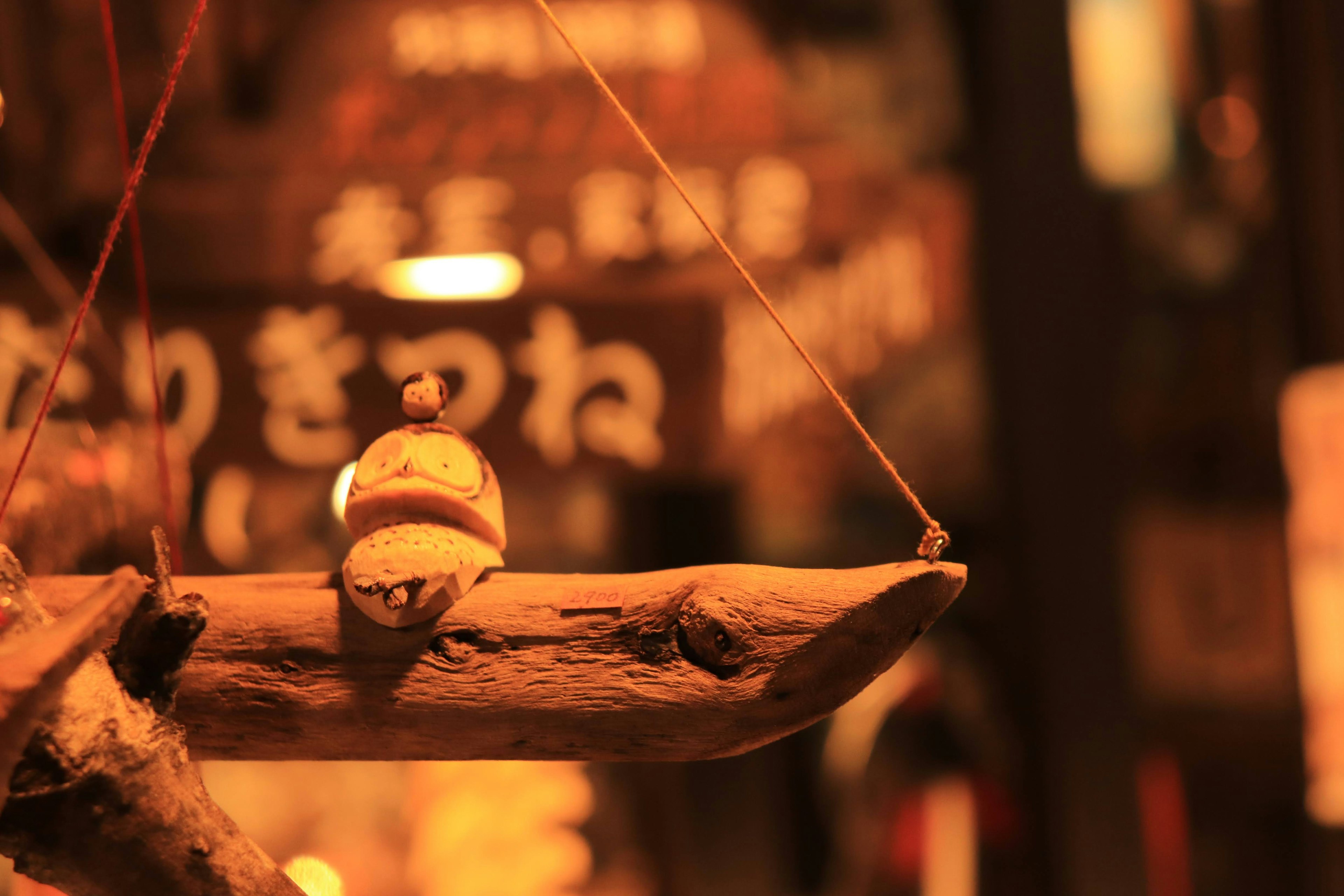 Wooden hanging decoration with Japanese signs in warm lighting