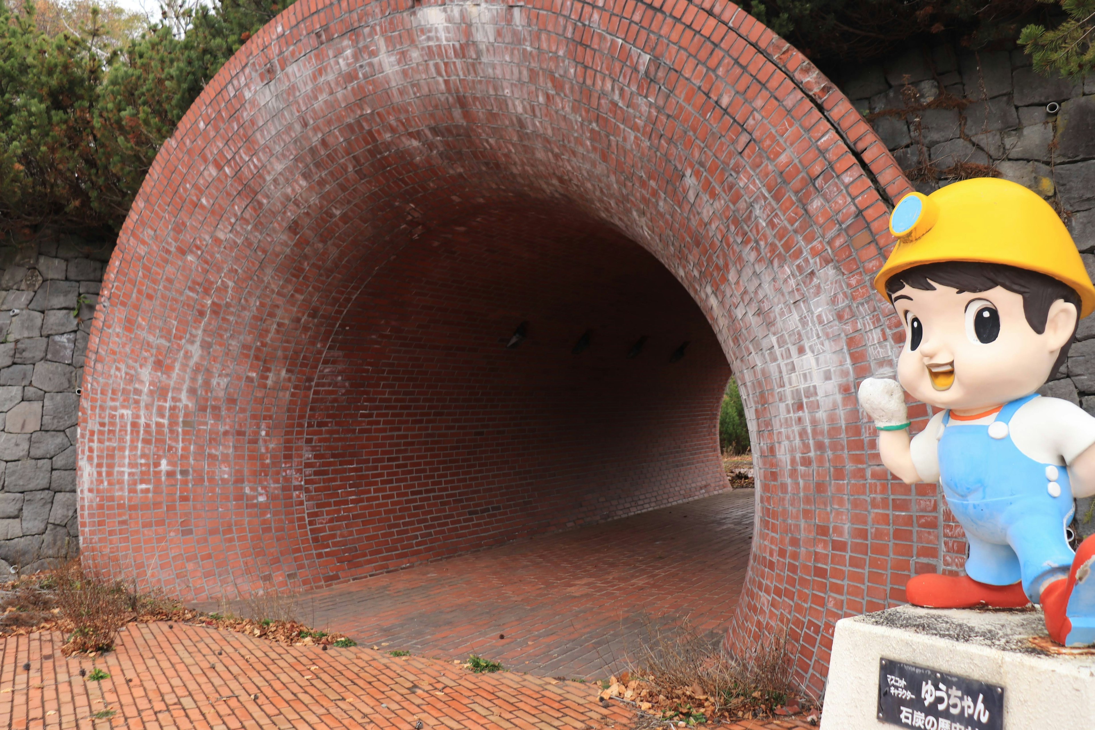 Brick tunnel with a character statue on the side