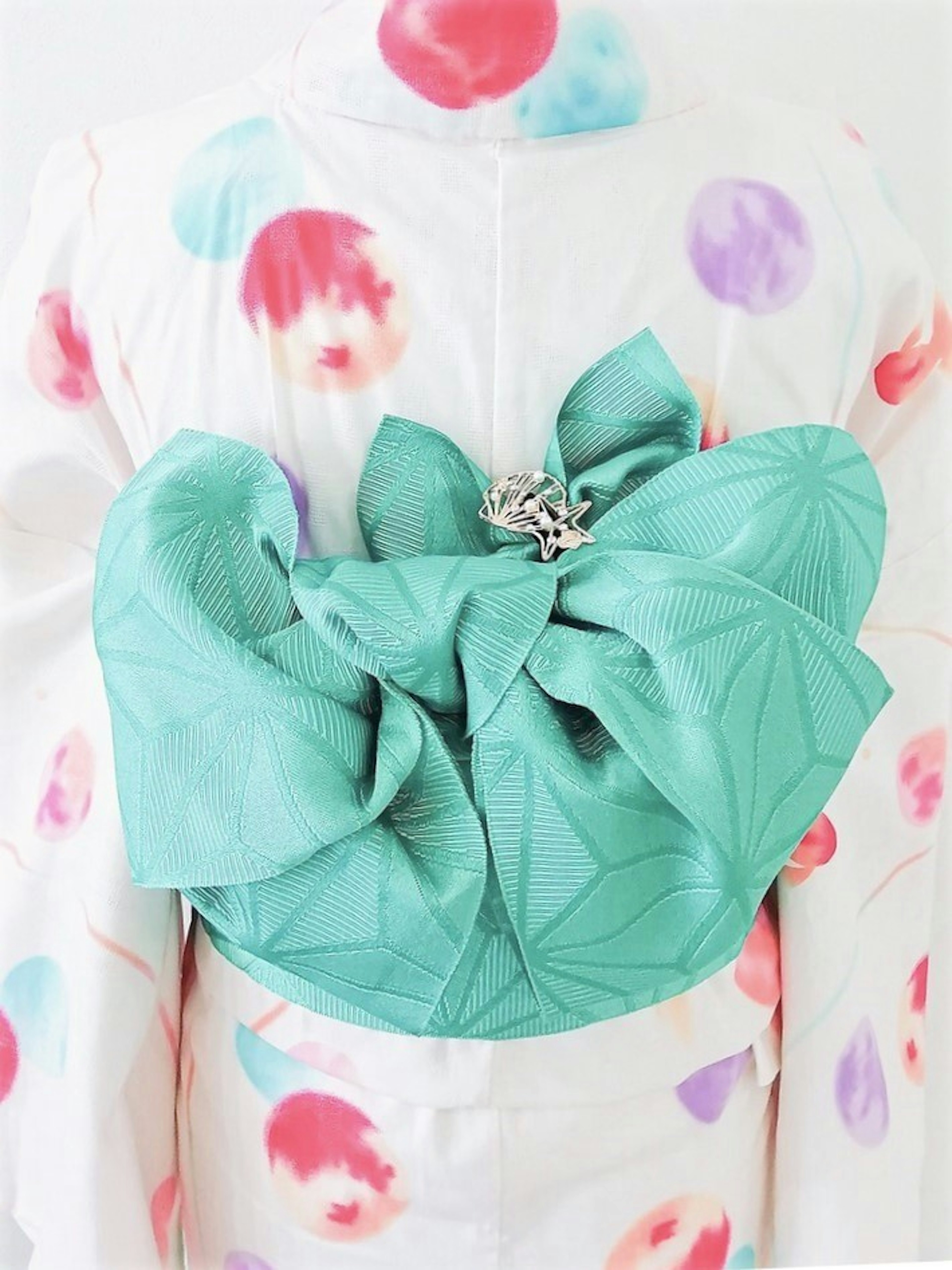 Kimono with colorful polka dots on a white background and an emerald green obi