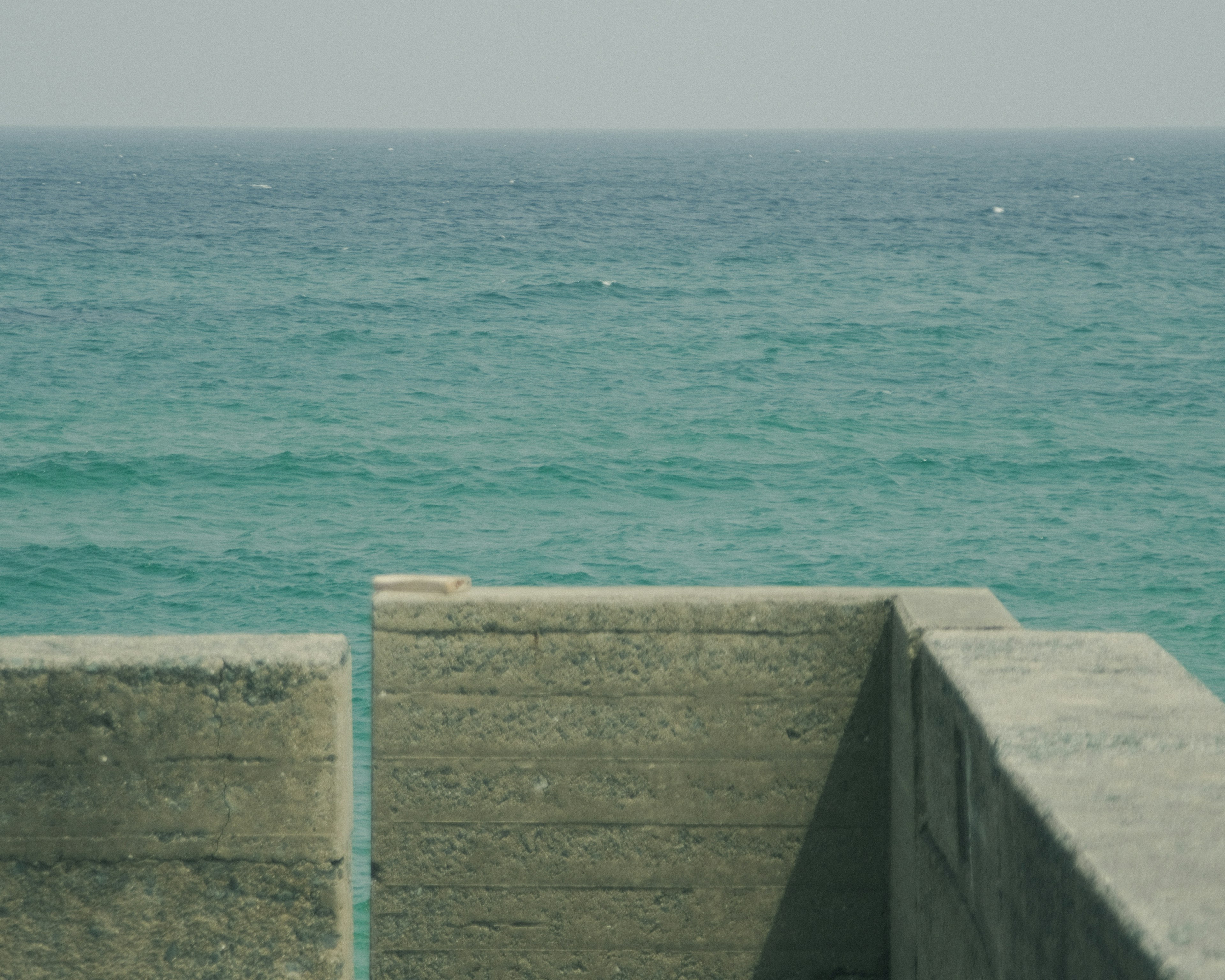 View of the ocean with a concrete structure