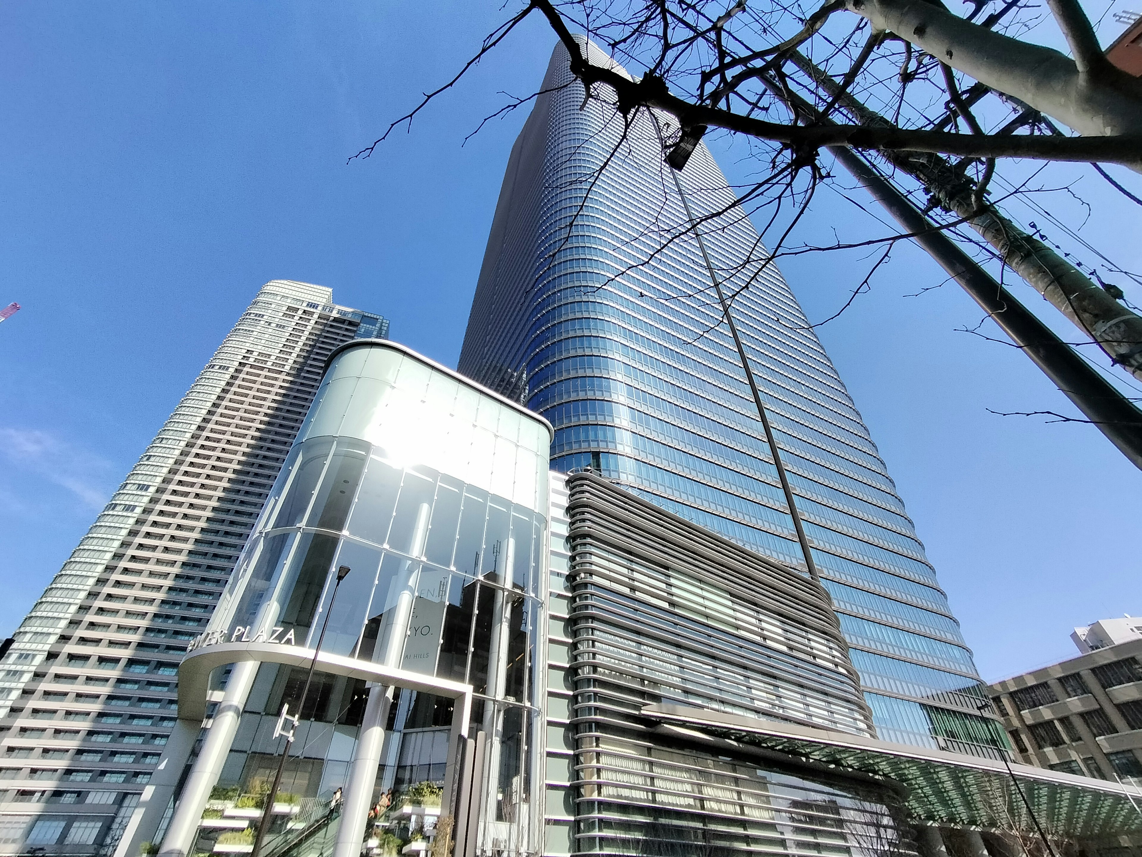 Combination of skyscrapers and modern architecture under bright blue sky