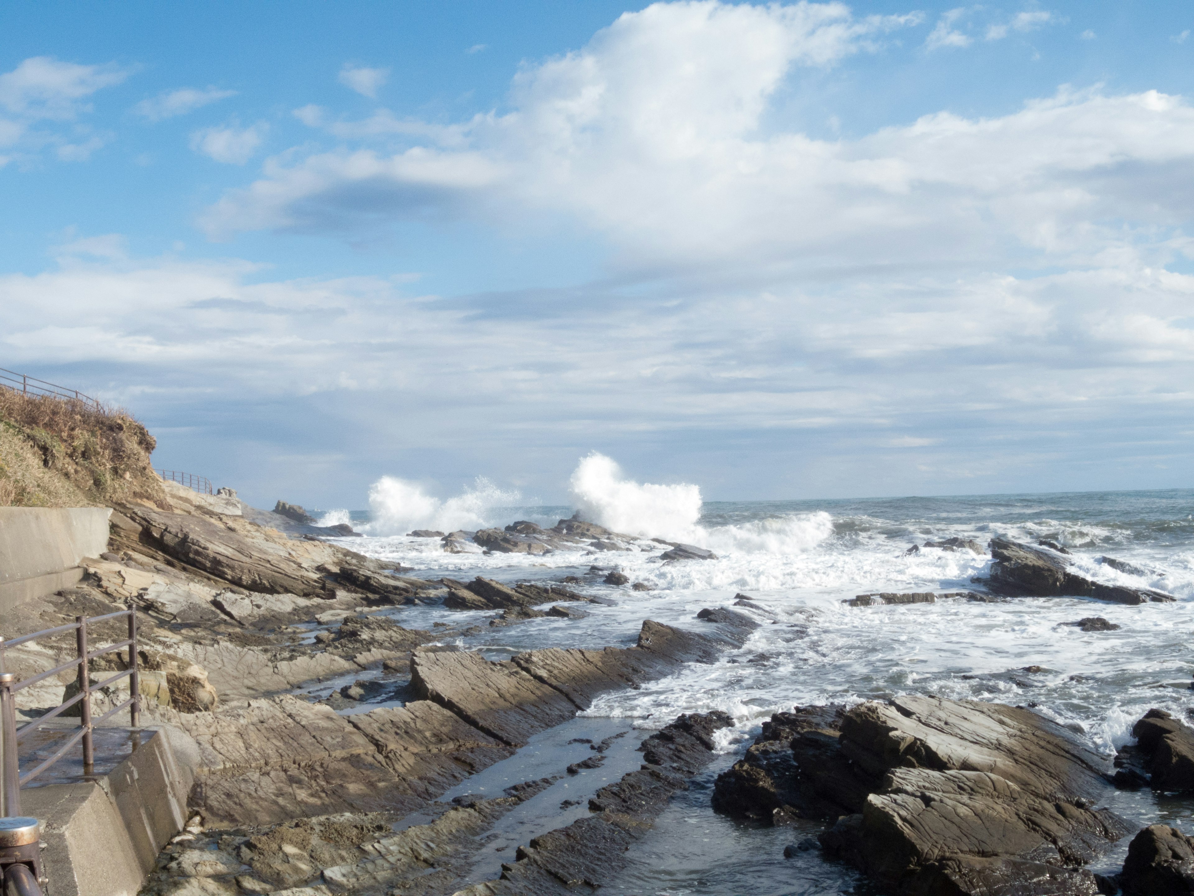 Seaside view with waves crashing on rocks