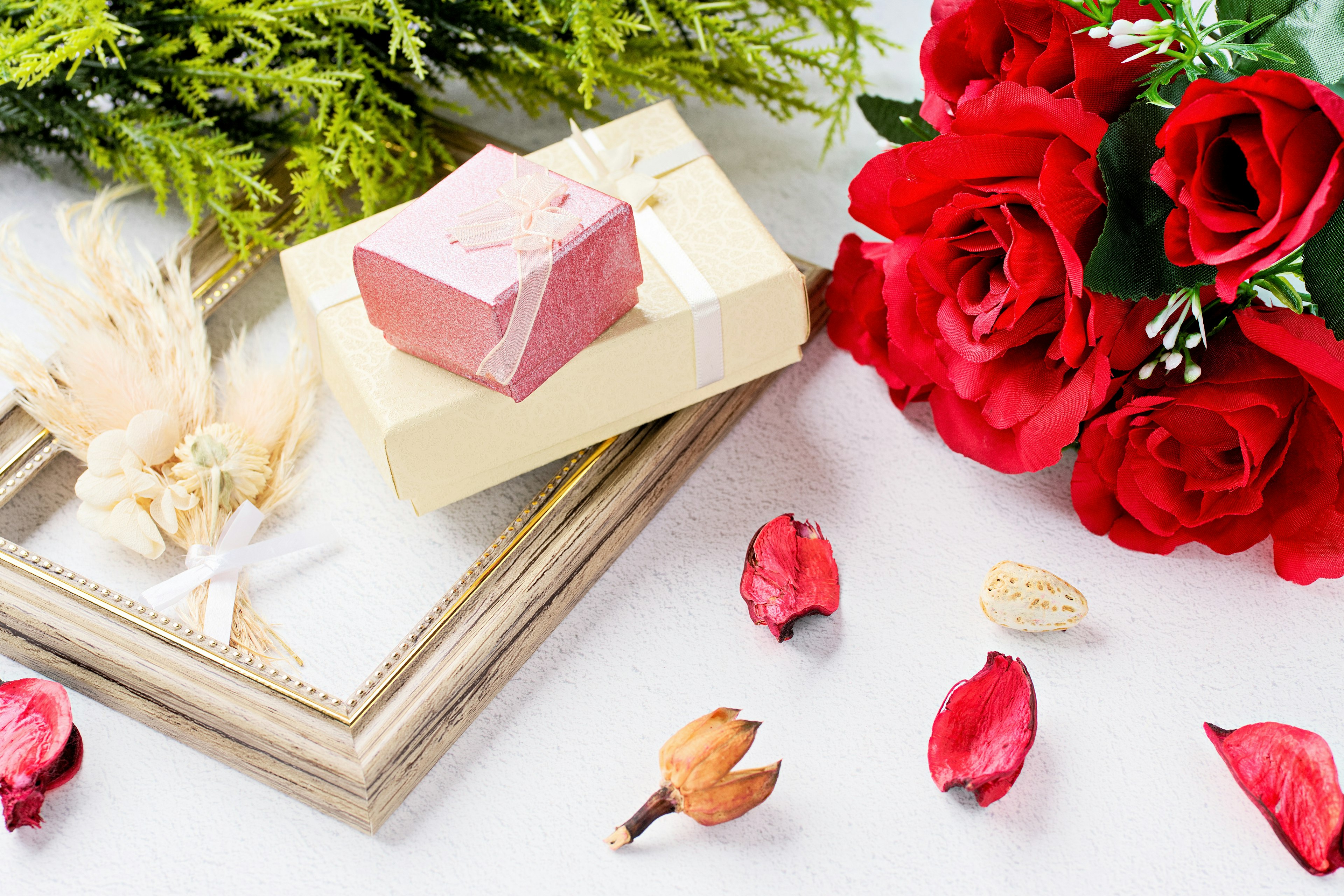 Still life with red roses and a beautifully wrapped soap on a table