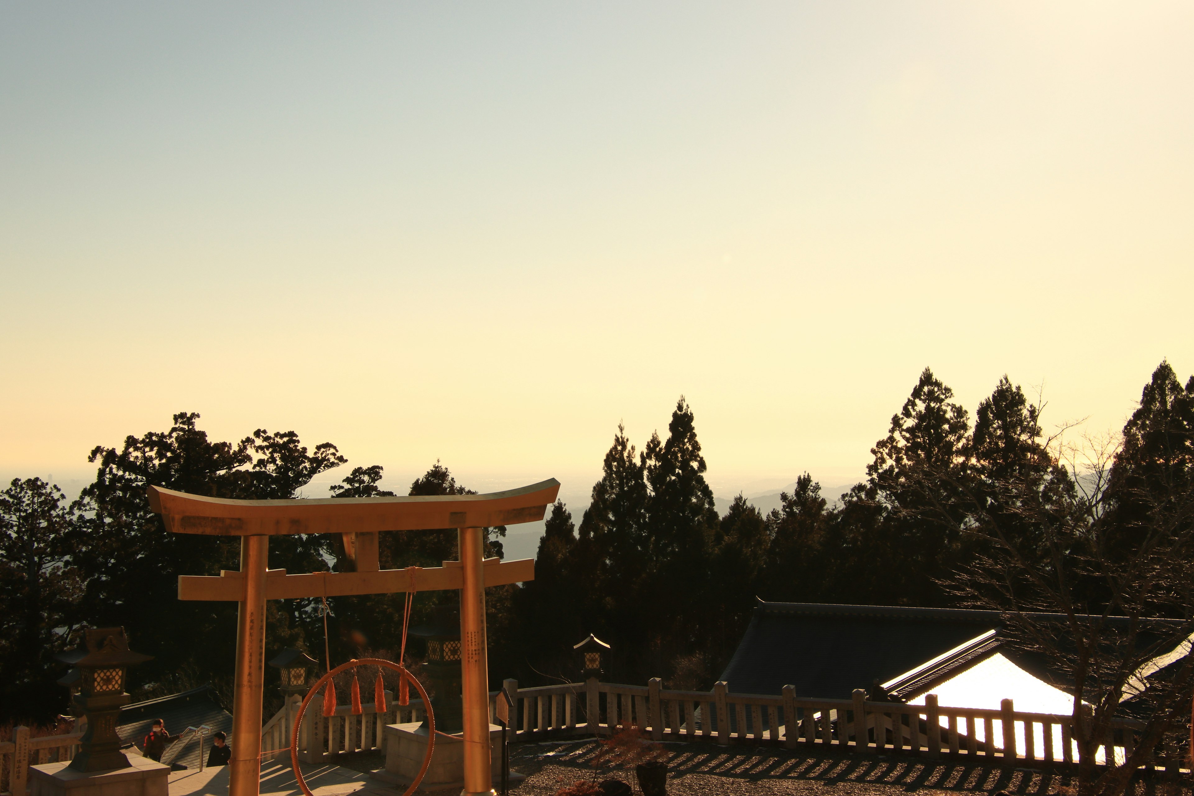 Vista escénica de un torii con siluetas de árboles en una montaña