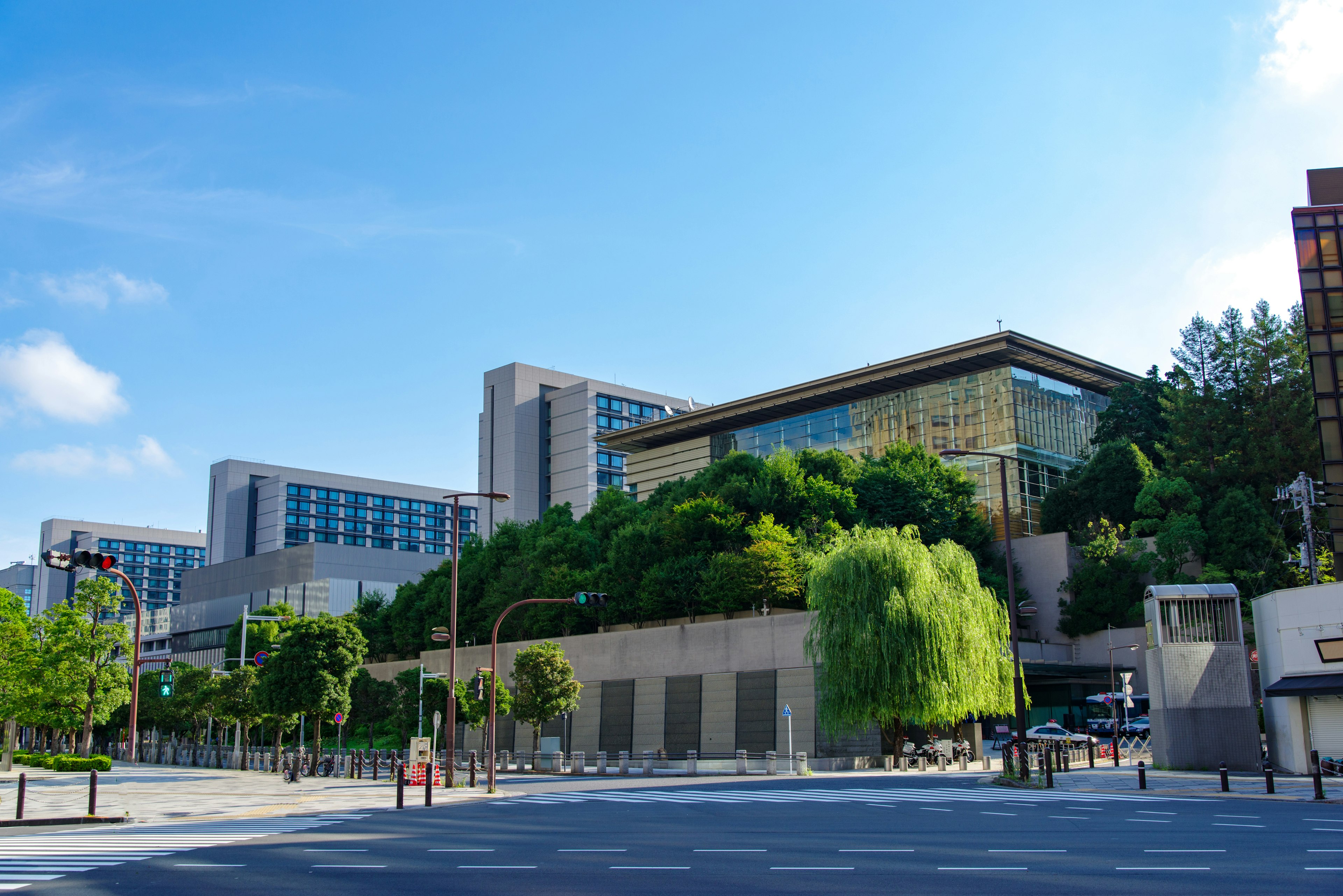 A landscape featuring a green building under a blue sky