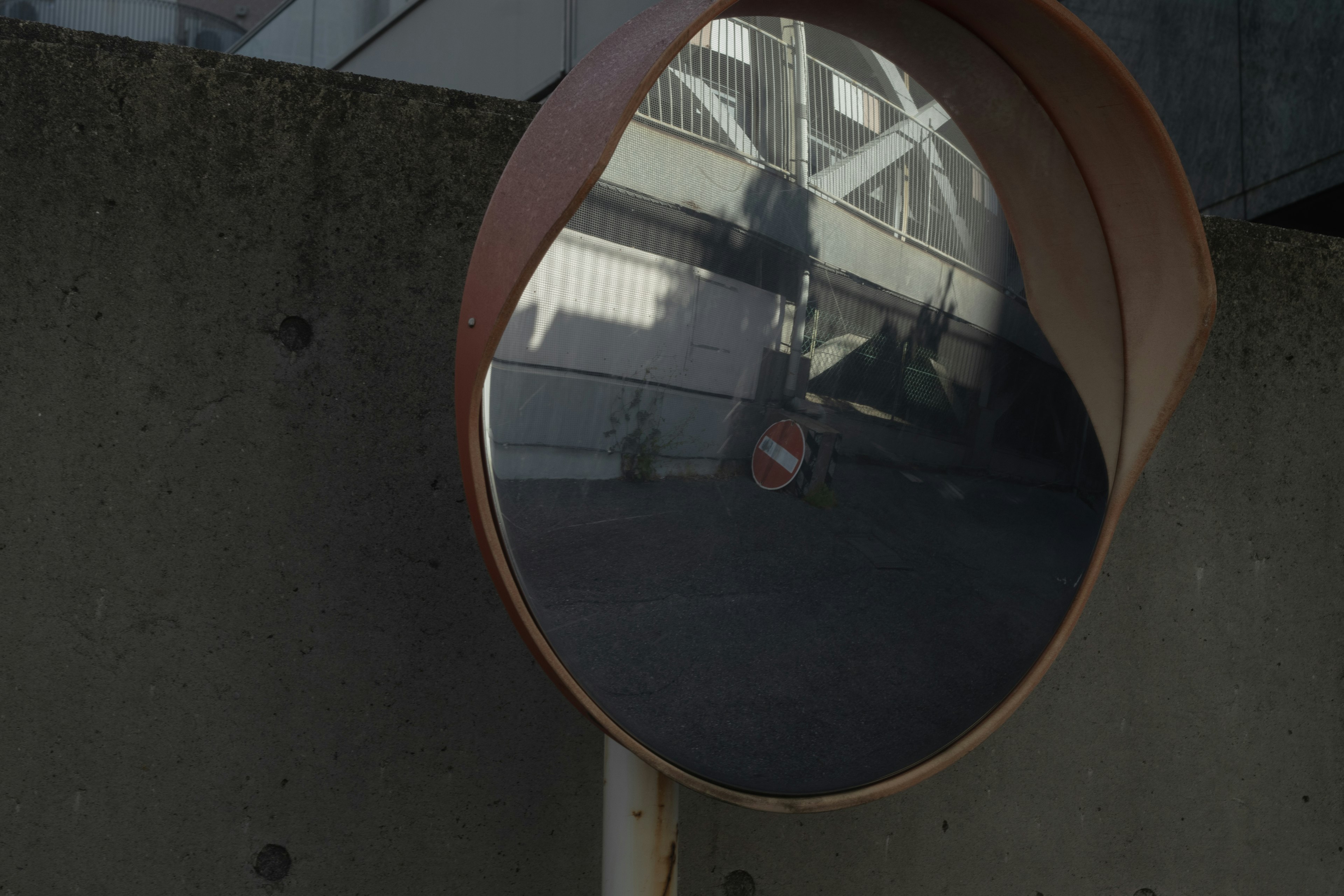 Reflective convex mirror showing surrounding structures