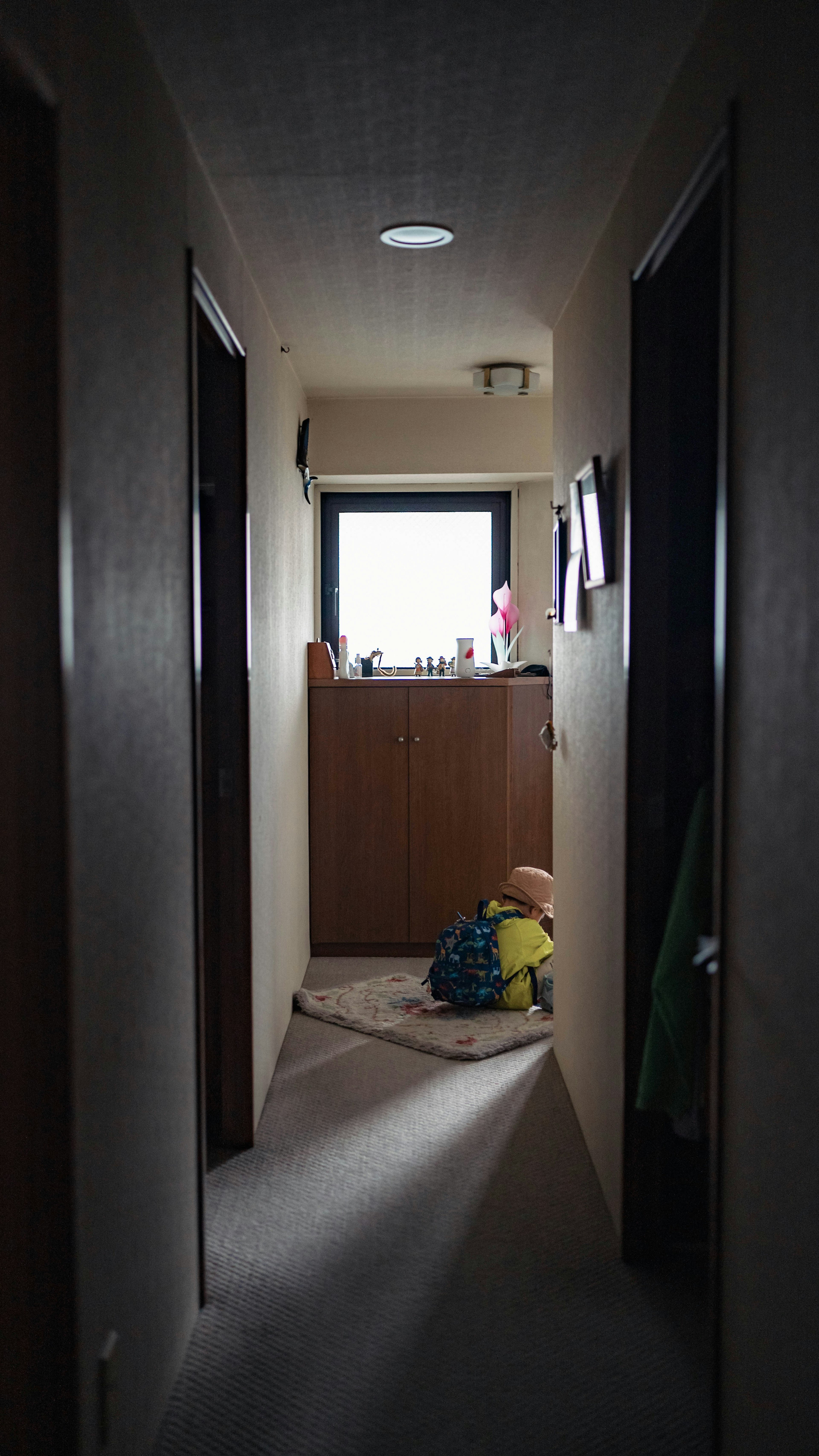 Dark hallway with a window and furniture visible