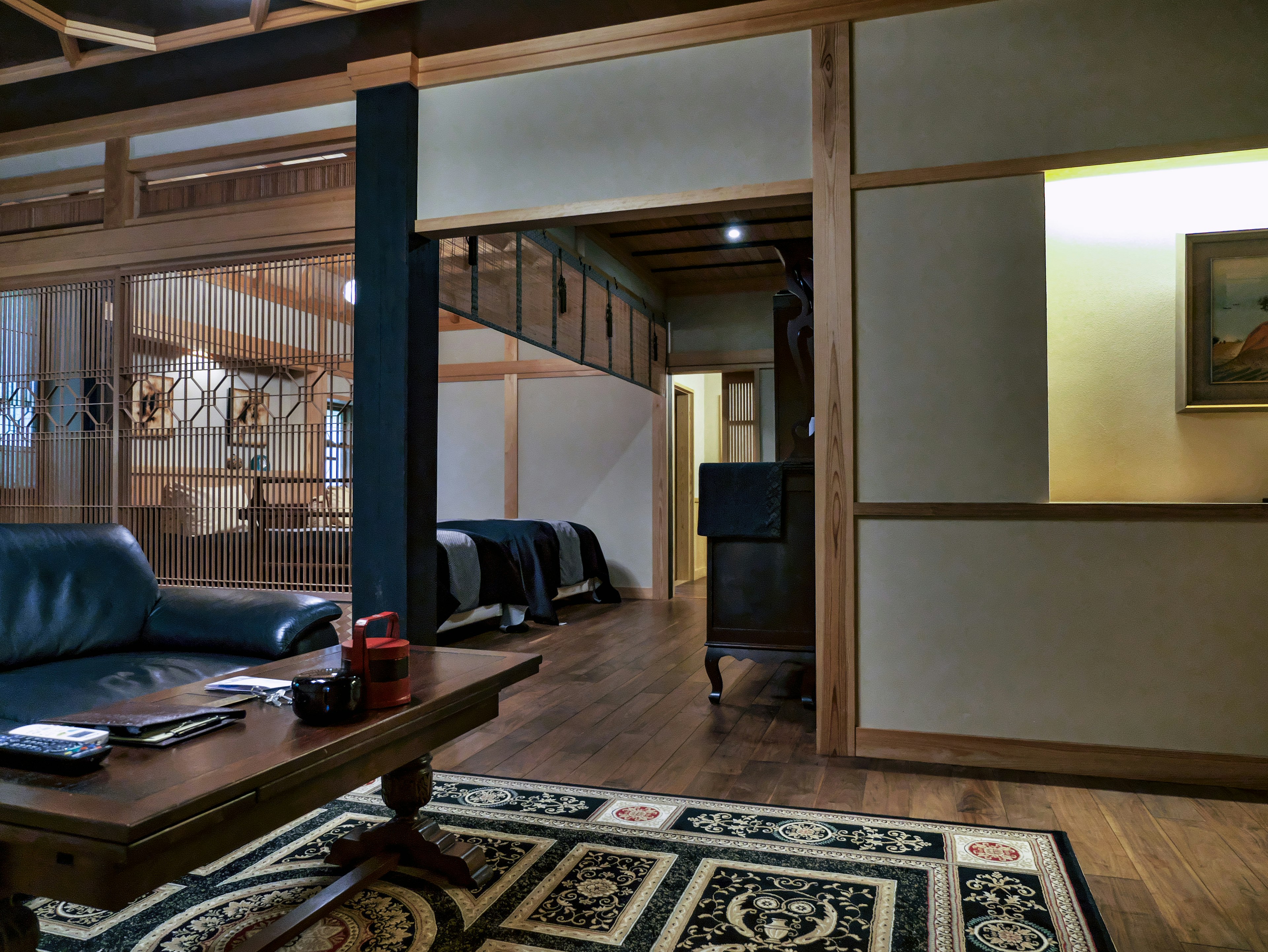 A room featuring a blue sofa and wooden table in a traditional Japanese style