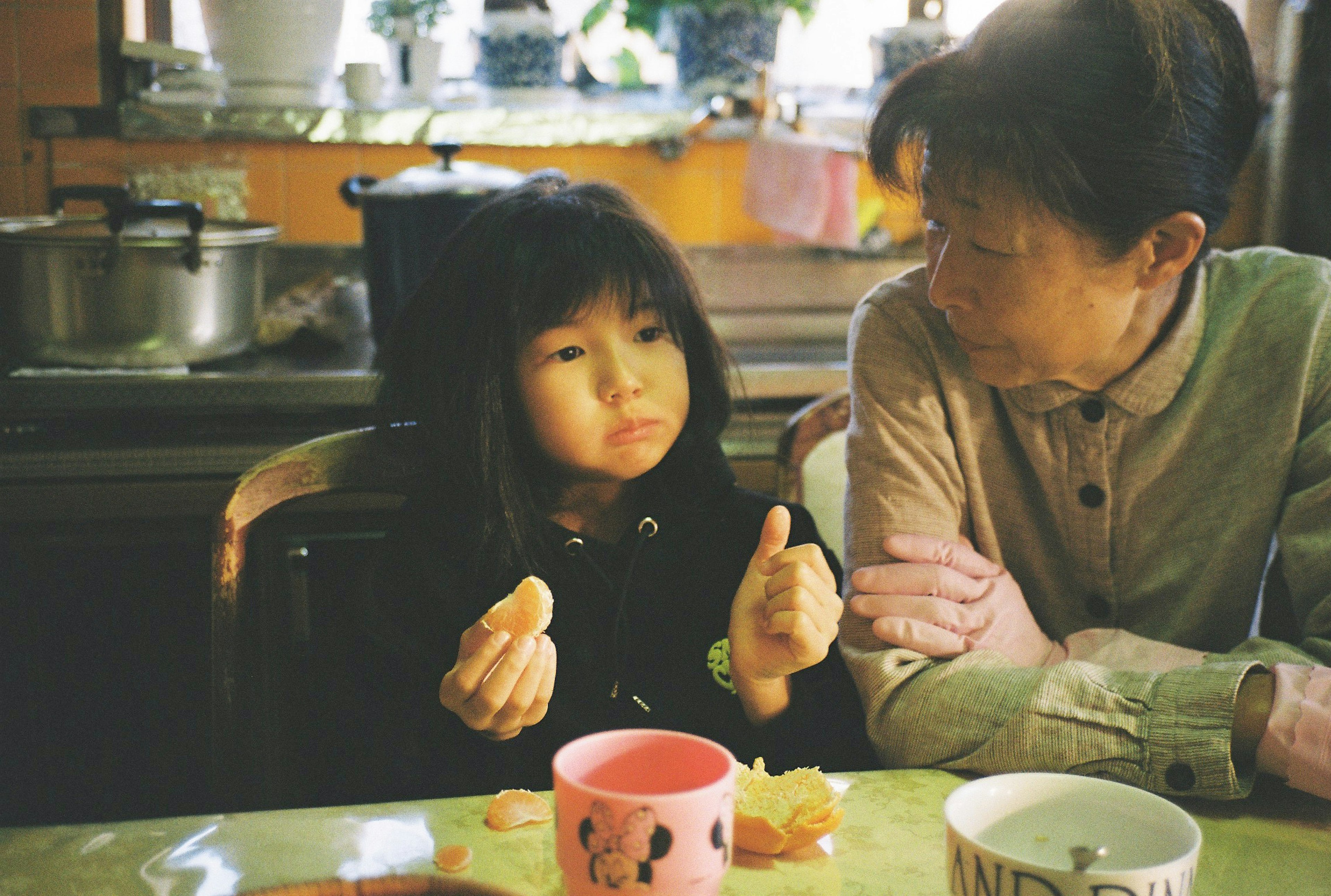 Una niña y su abuela disfrutando del tiempo juntas en una mesa