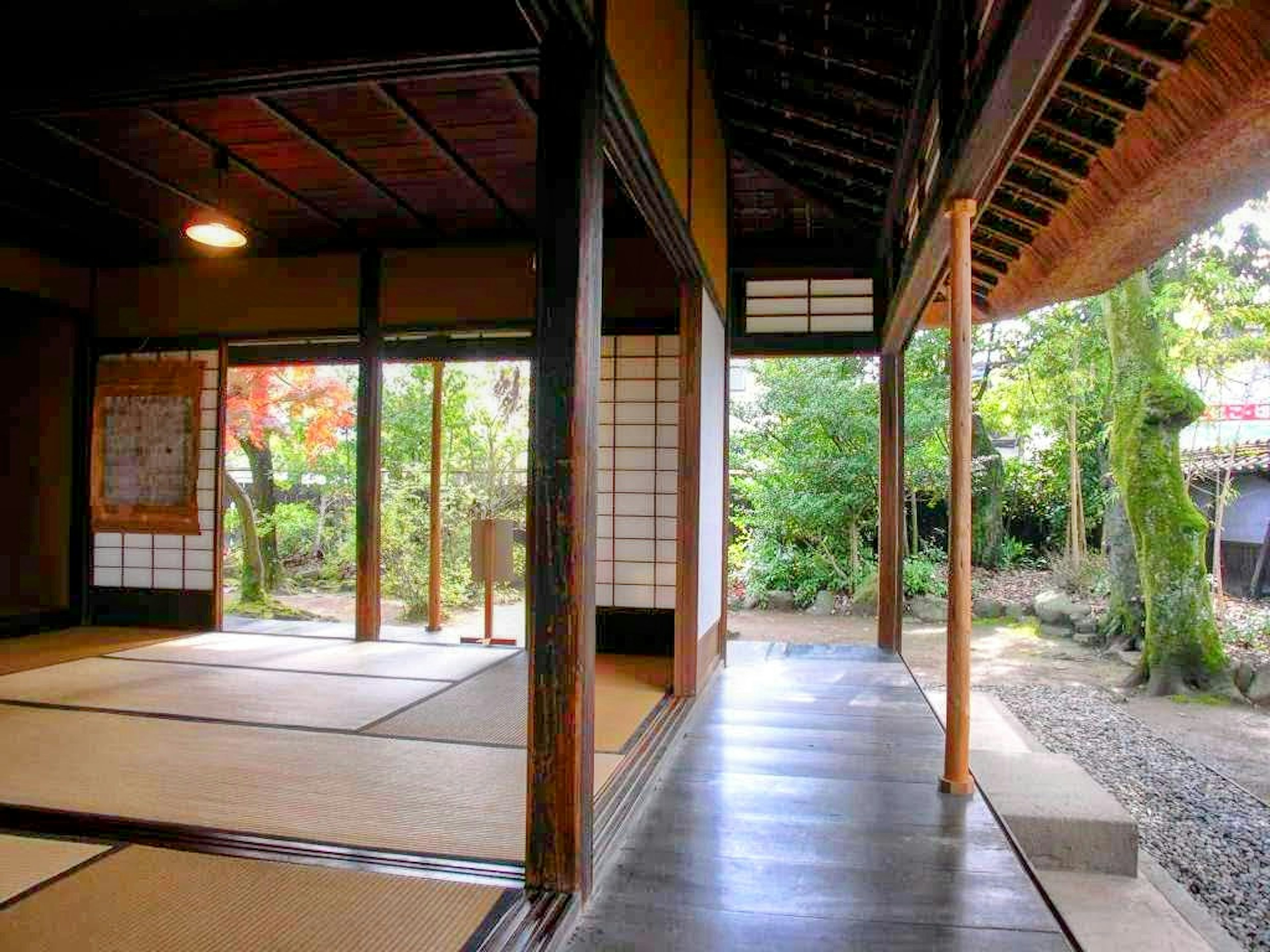 Interior view of a traditional Japanese house featuring tatami mats and wooden pillars