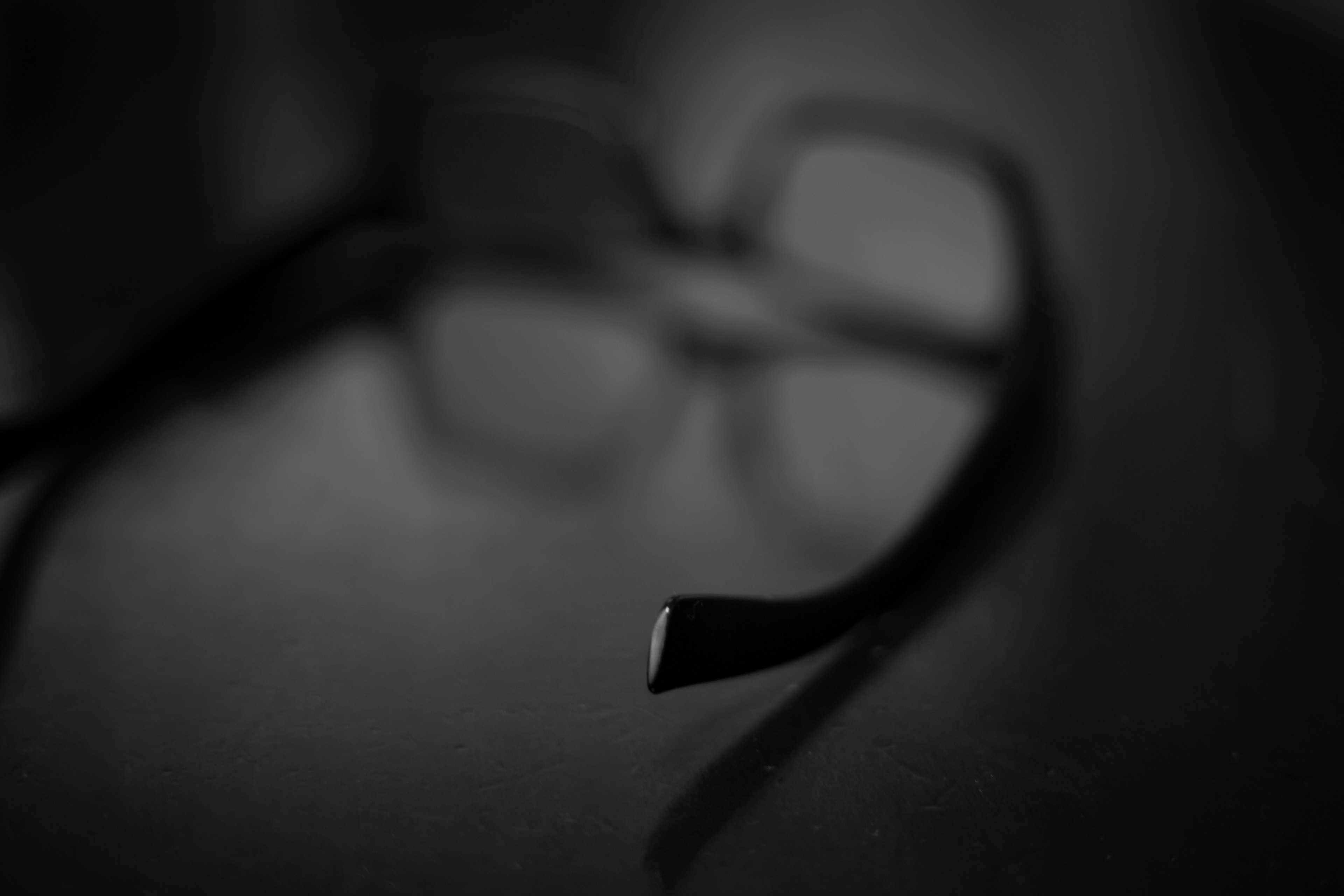 Blurred black and white image of eyeglass frames