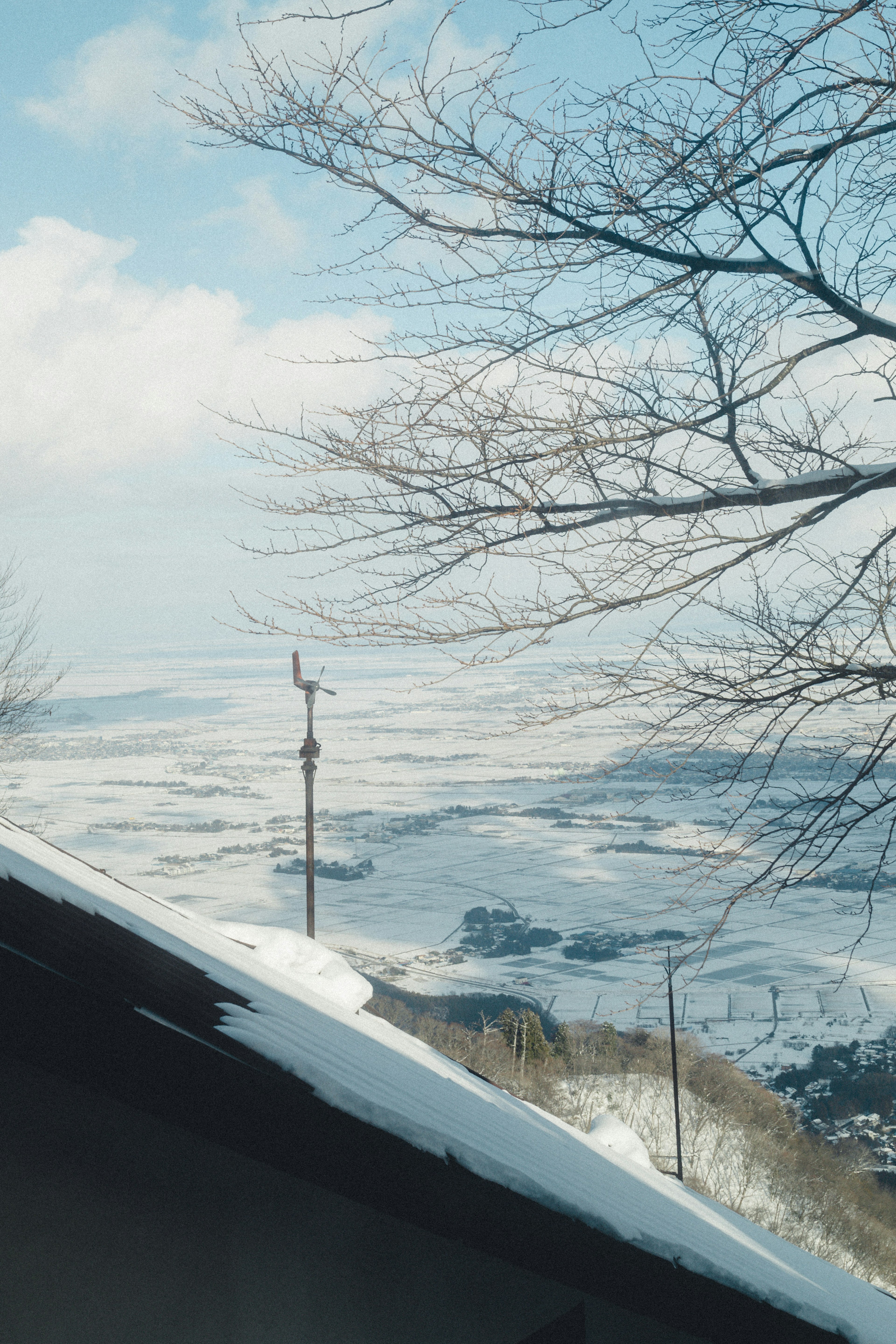 Snow-covered landscape with a winter sky and a serene mountain view