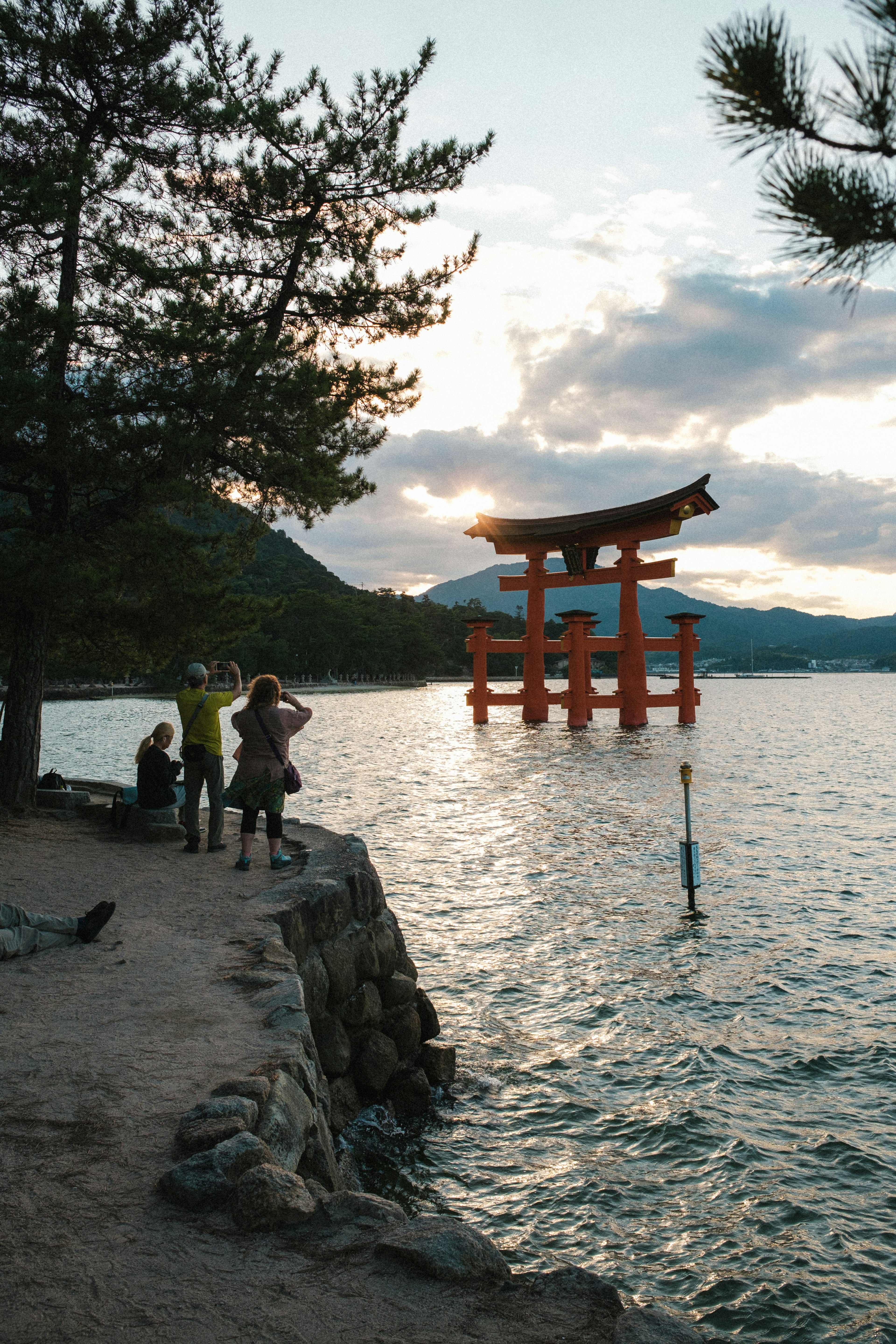 海に浮かぶ赤い鳥居と夕日を背景にした風景