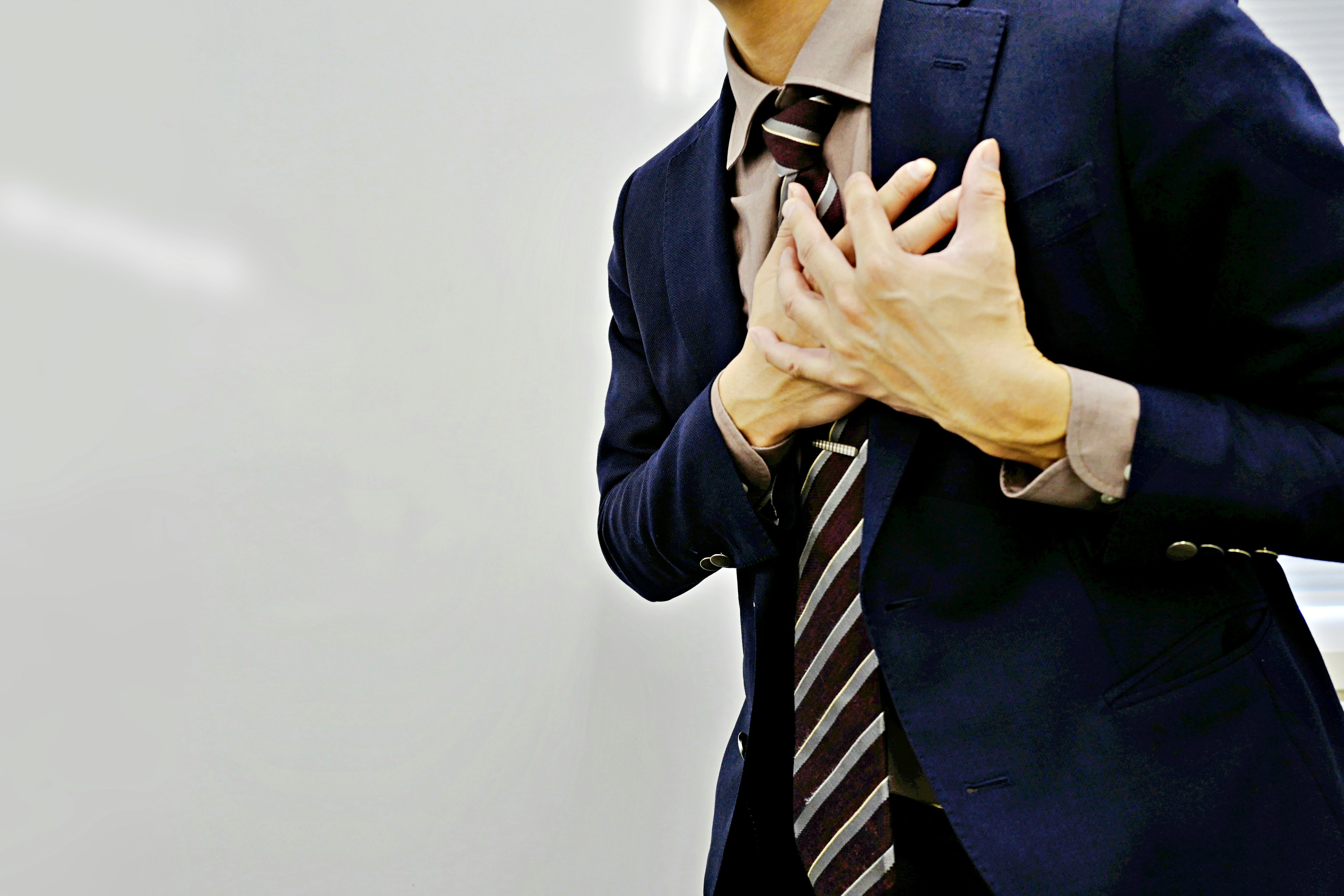 Businessman holding his chest in distress