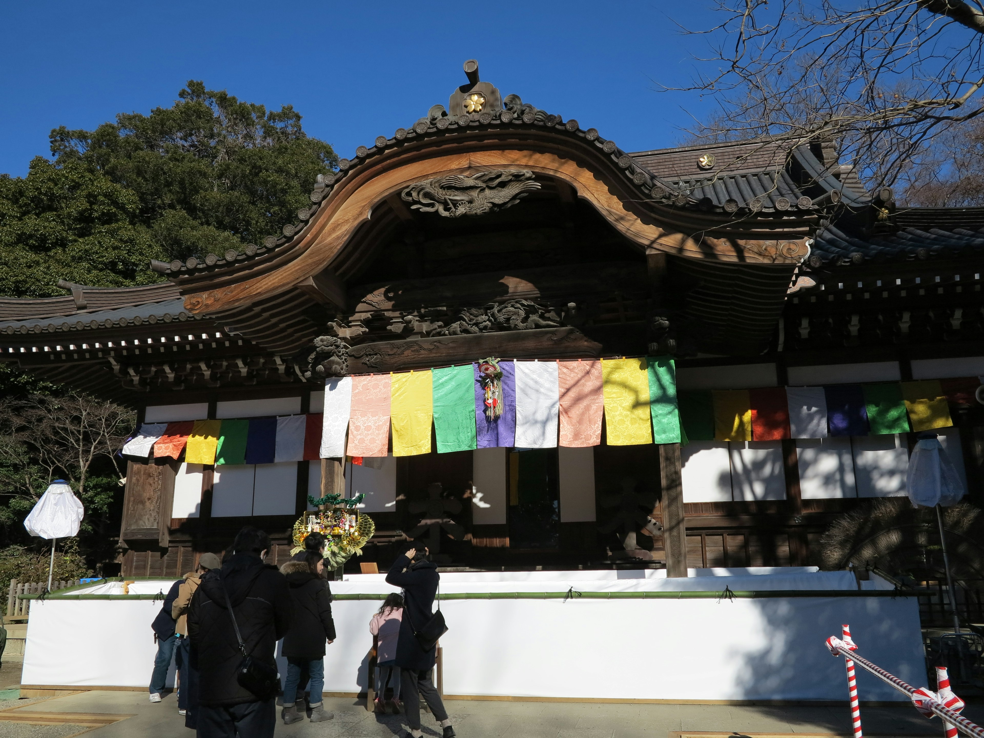 Temple japonais traditionnel avec des banderoles colorées et des visiteurs