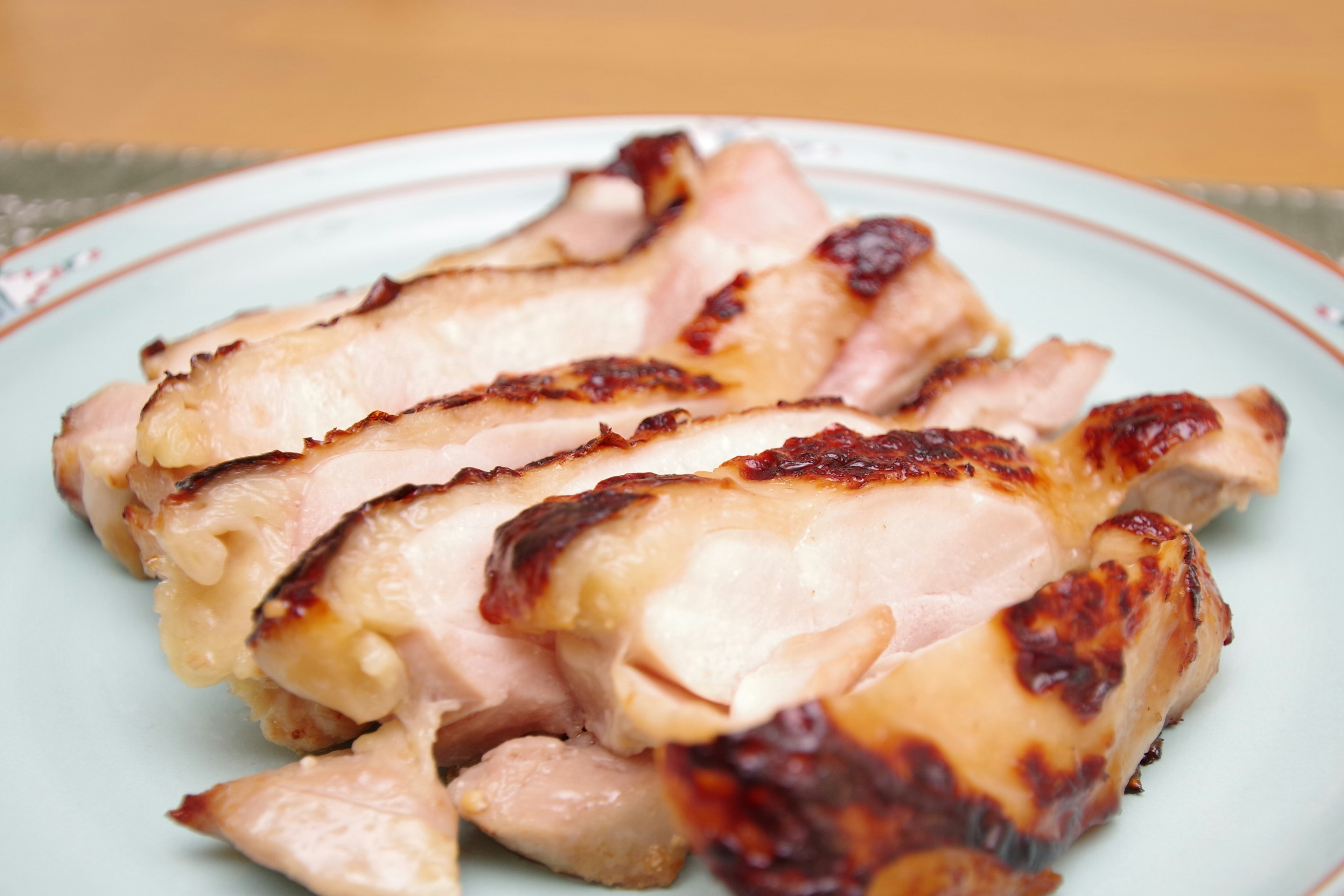 Sliced grilled chicken served on a plate