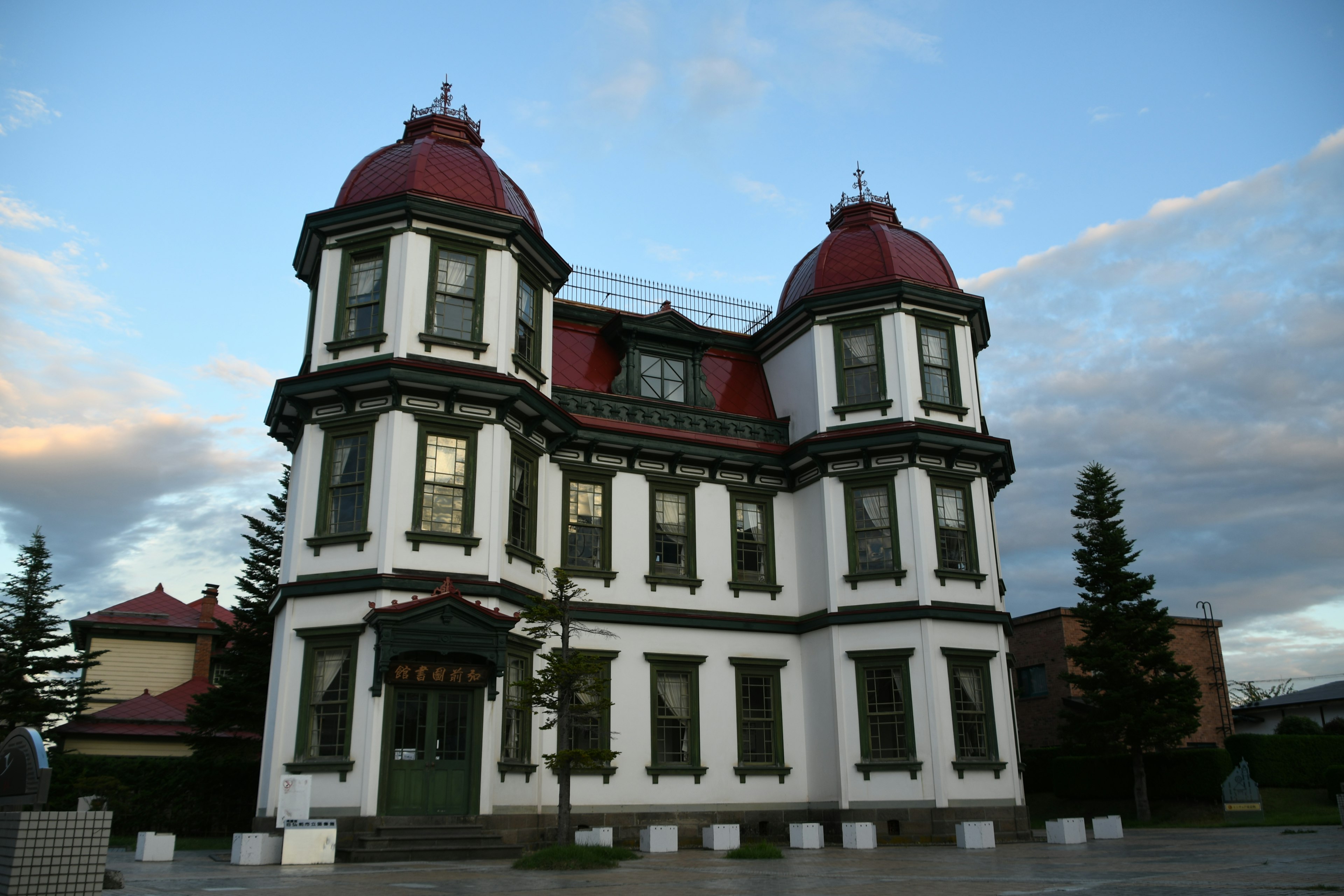 Exterior of a white building with red dome roofs