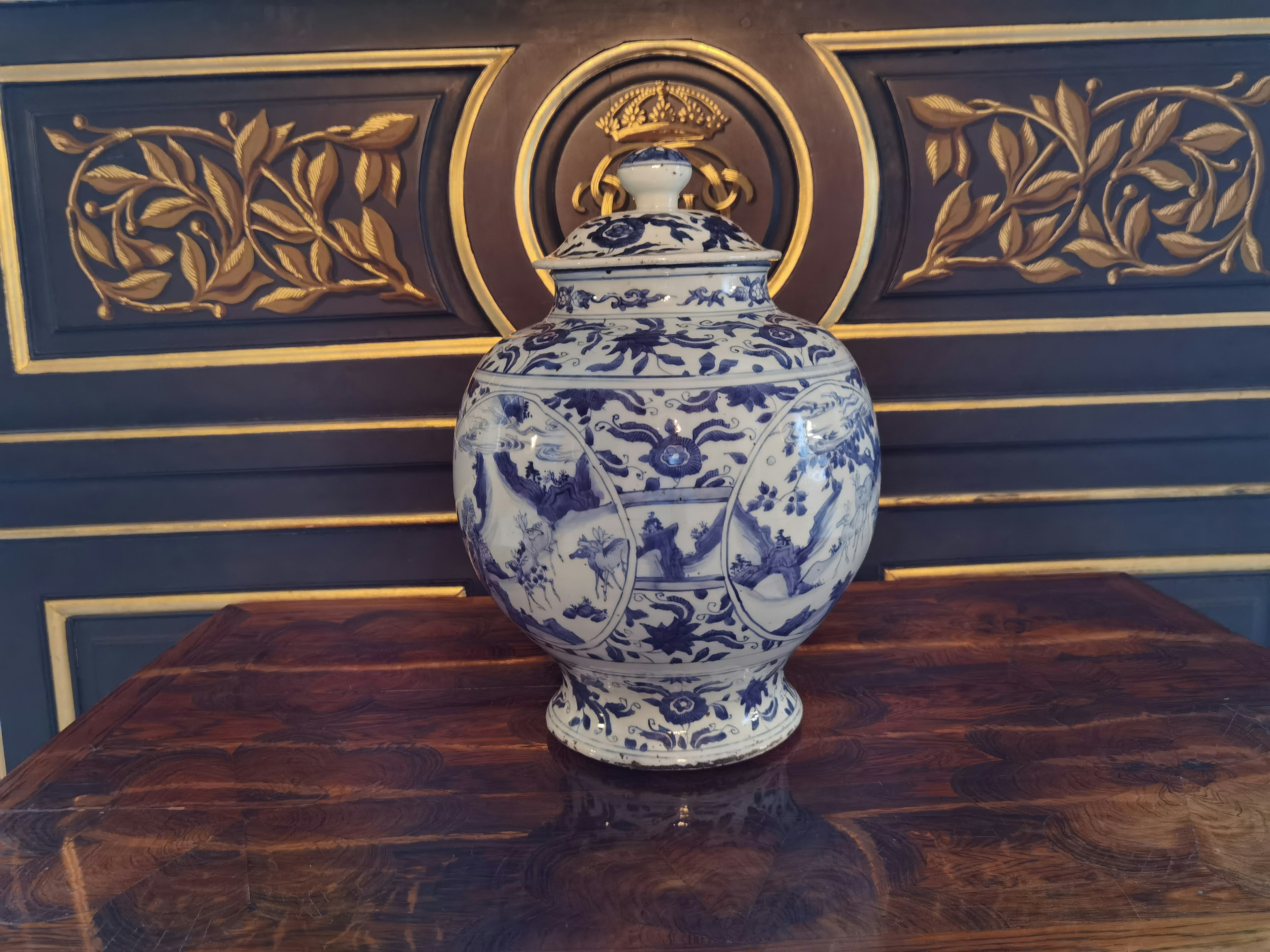 Blue floral patterned ceramic jar placed against a black background