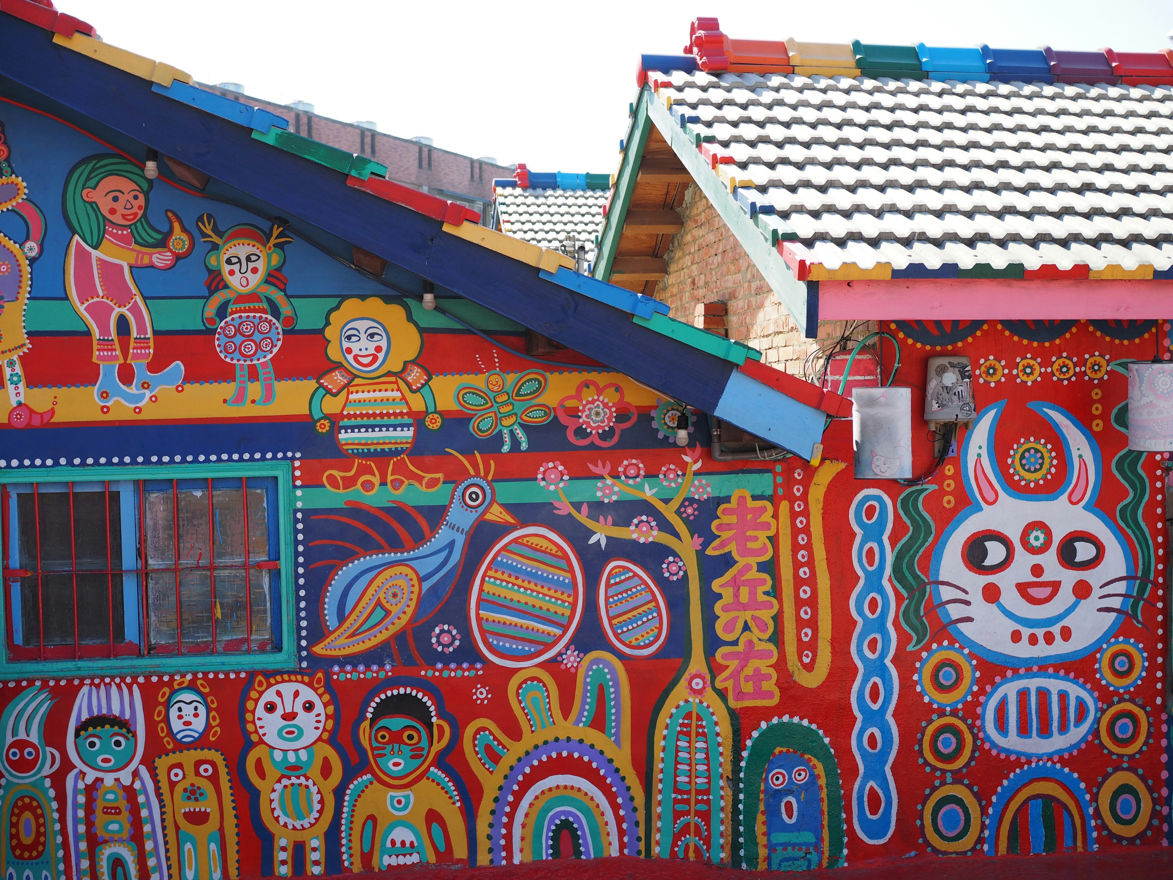 Colorful artwork on the walls and roofs of a house