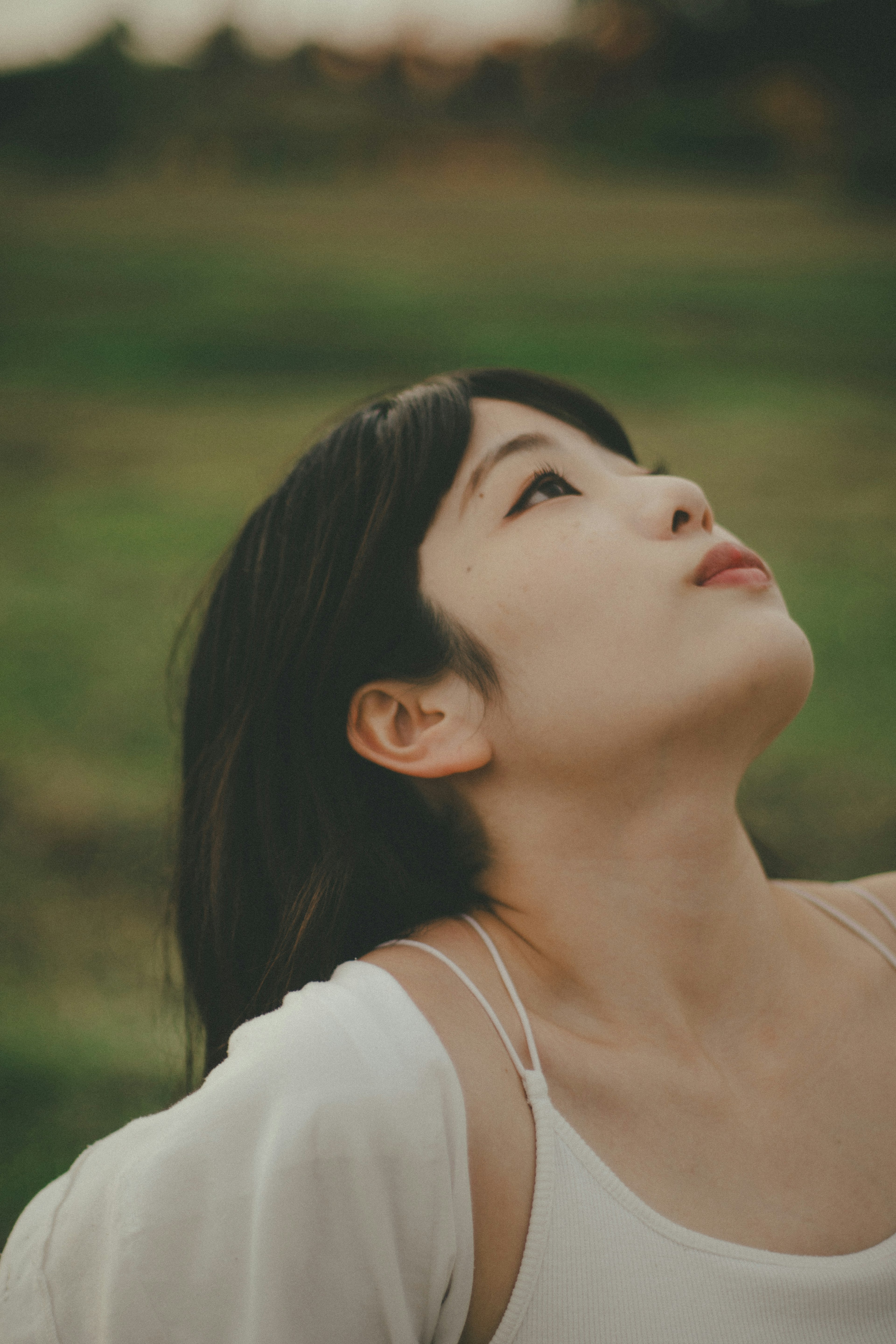 Una donna che guarda il cielo in un ambiente naturale