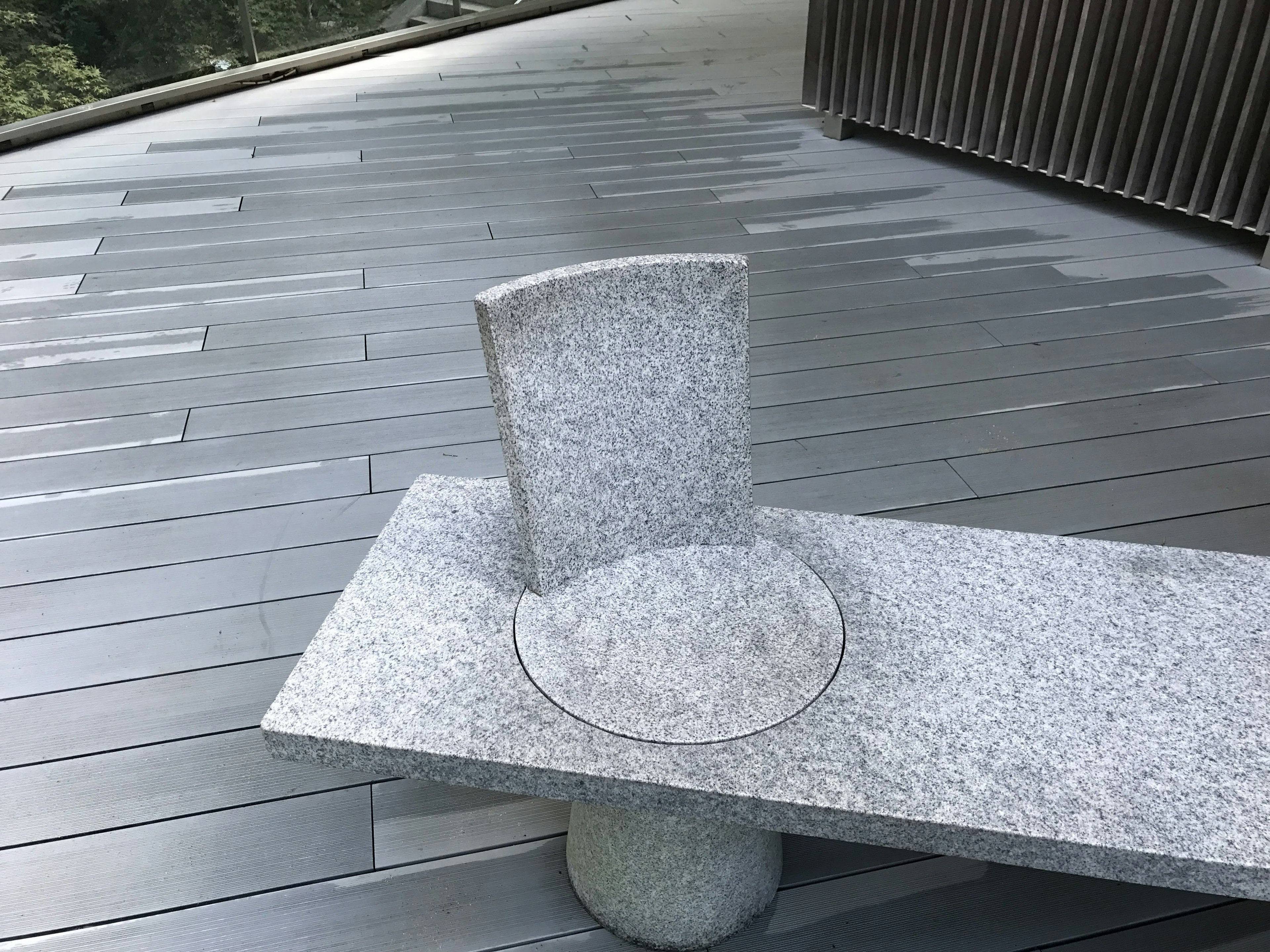 Modern terrace featuring a stone bench and chair