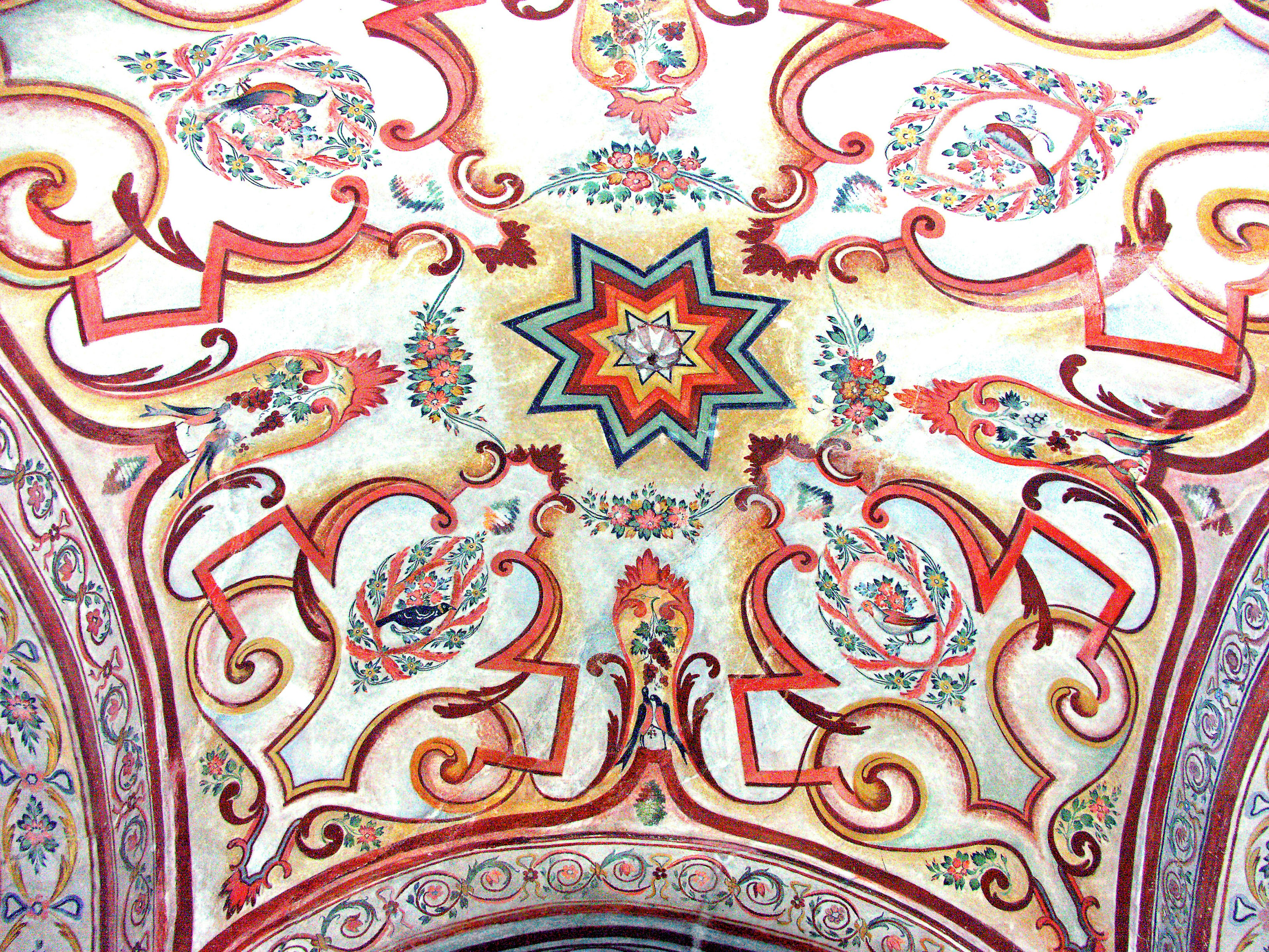 Vibrant ceiling design with ornate decorations colorful star shape at the center surrounded by floral and geometric patterns