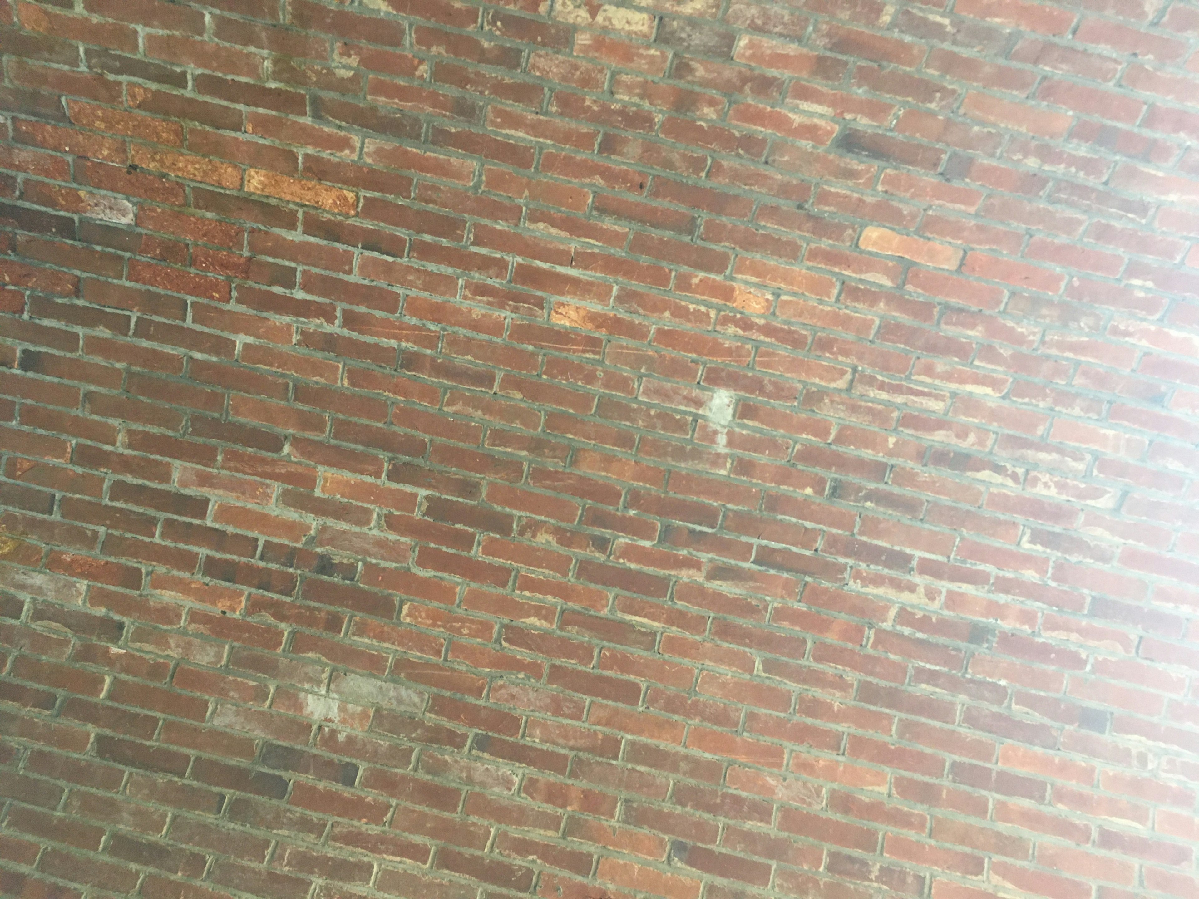 Textured red brick wall with visible imperfections