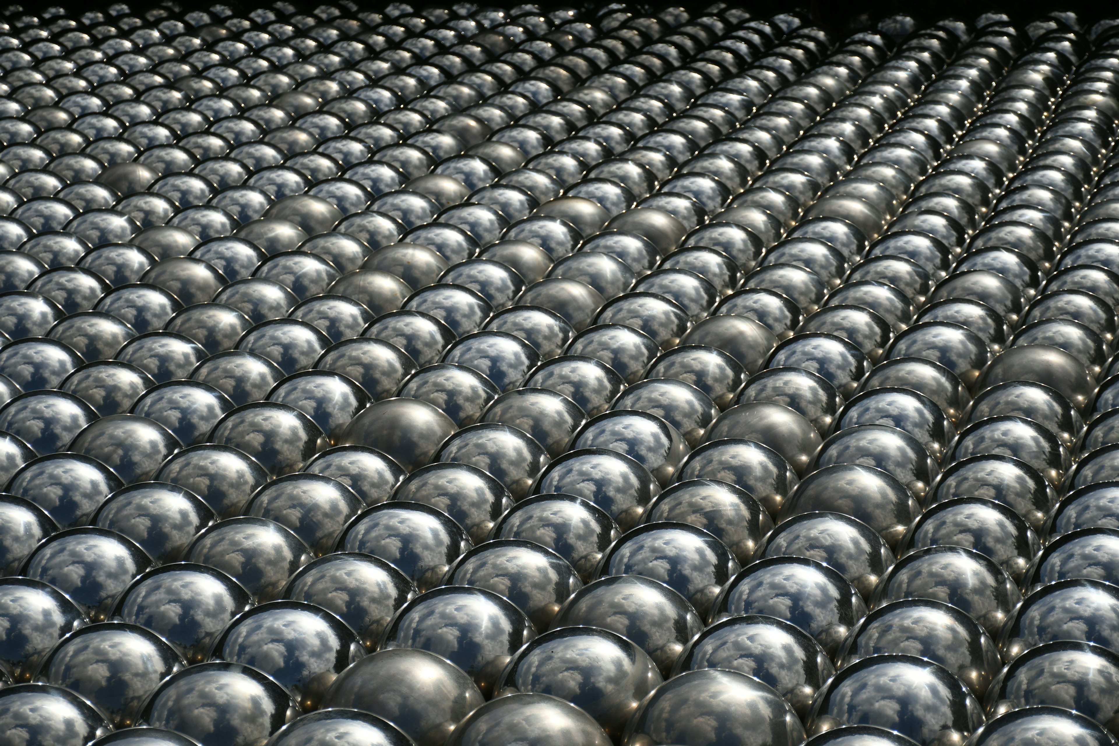 A geometric pattern of silver spheres arranged in a grid