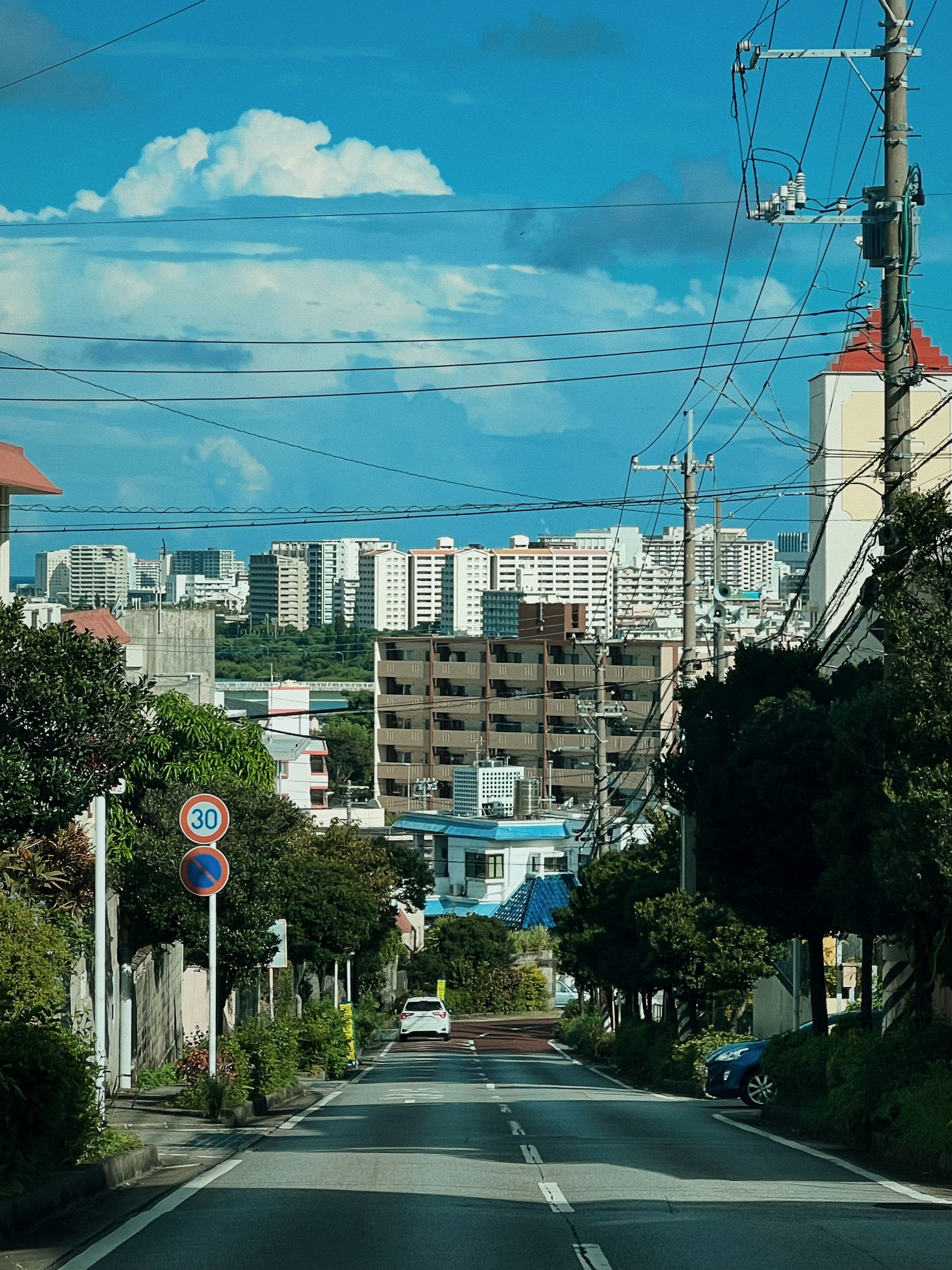 Residential street view with blue sky and clouds