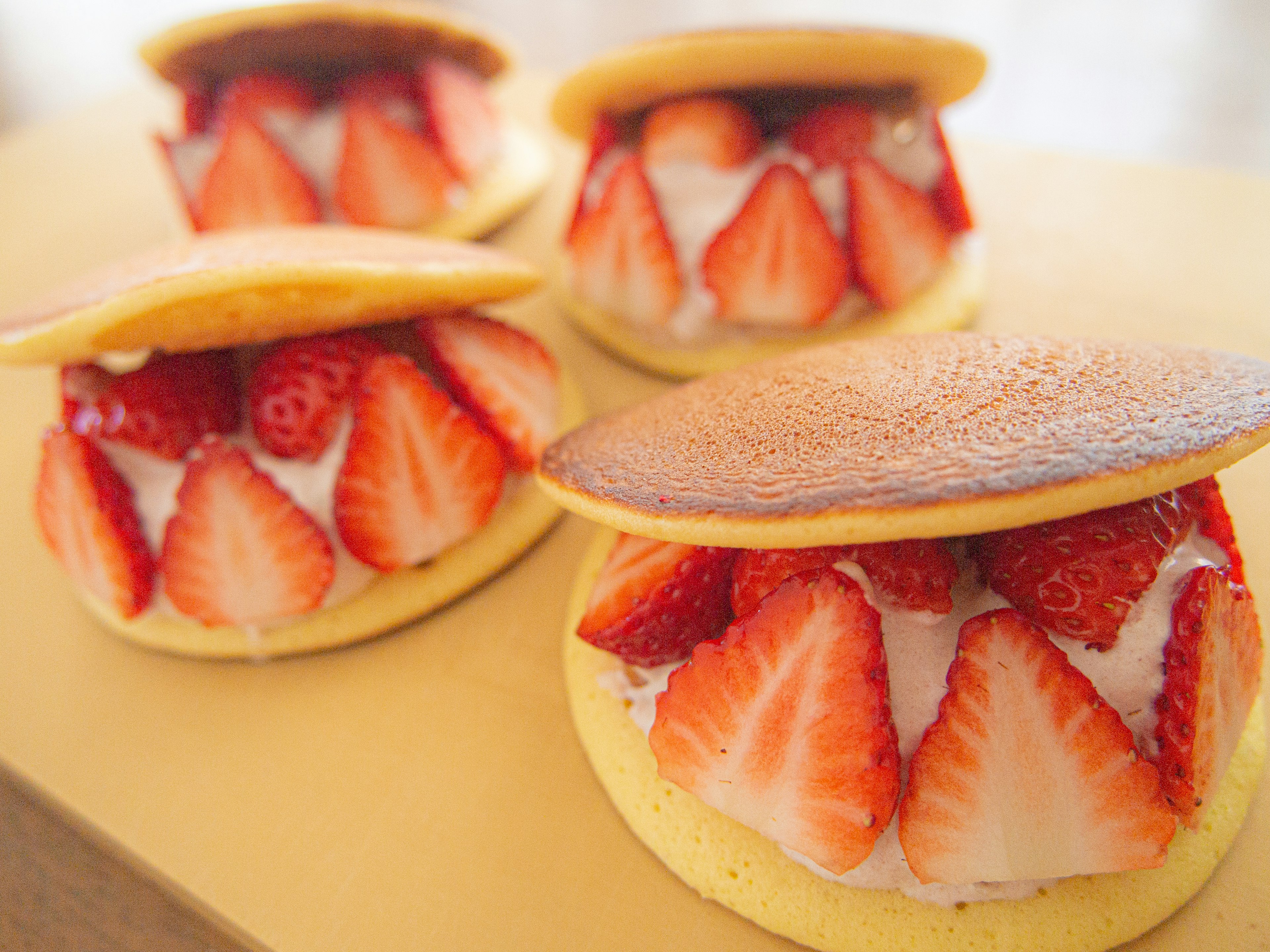 Japanese dessert featuring strawberries and cream in fluffy pancakes