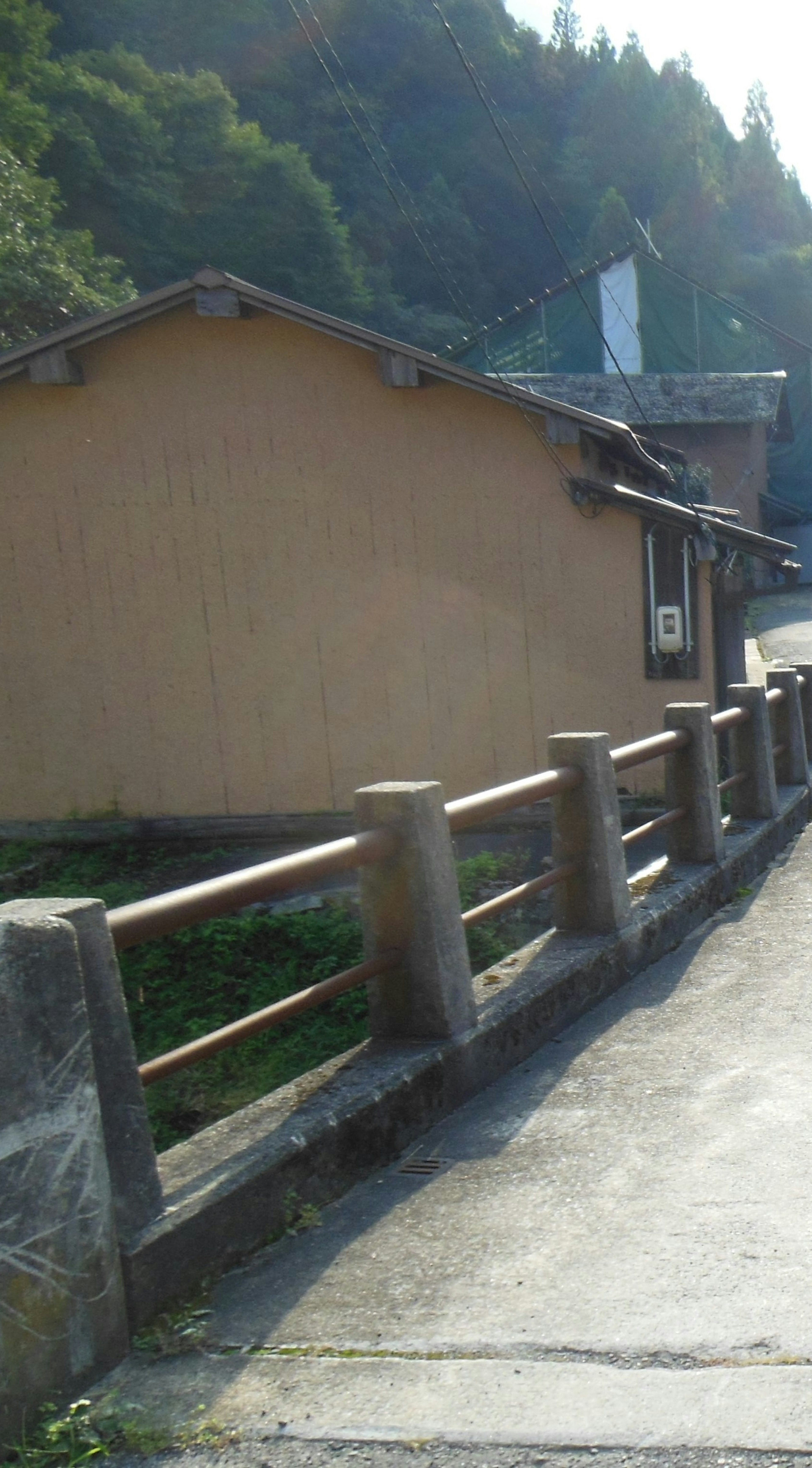 Scenic view of an old house and stone fence in the mountains