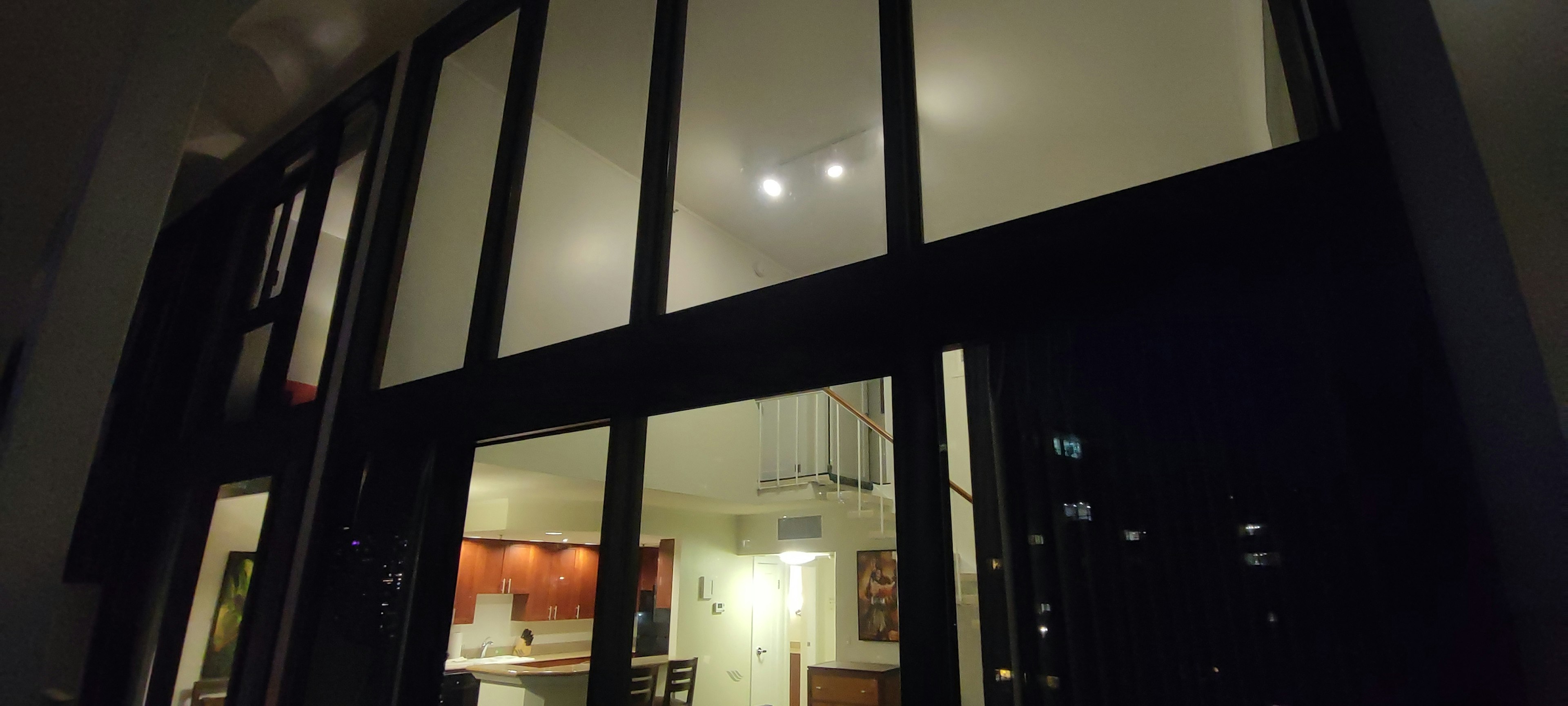 Large glass windows at night showing bright interior lights