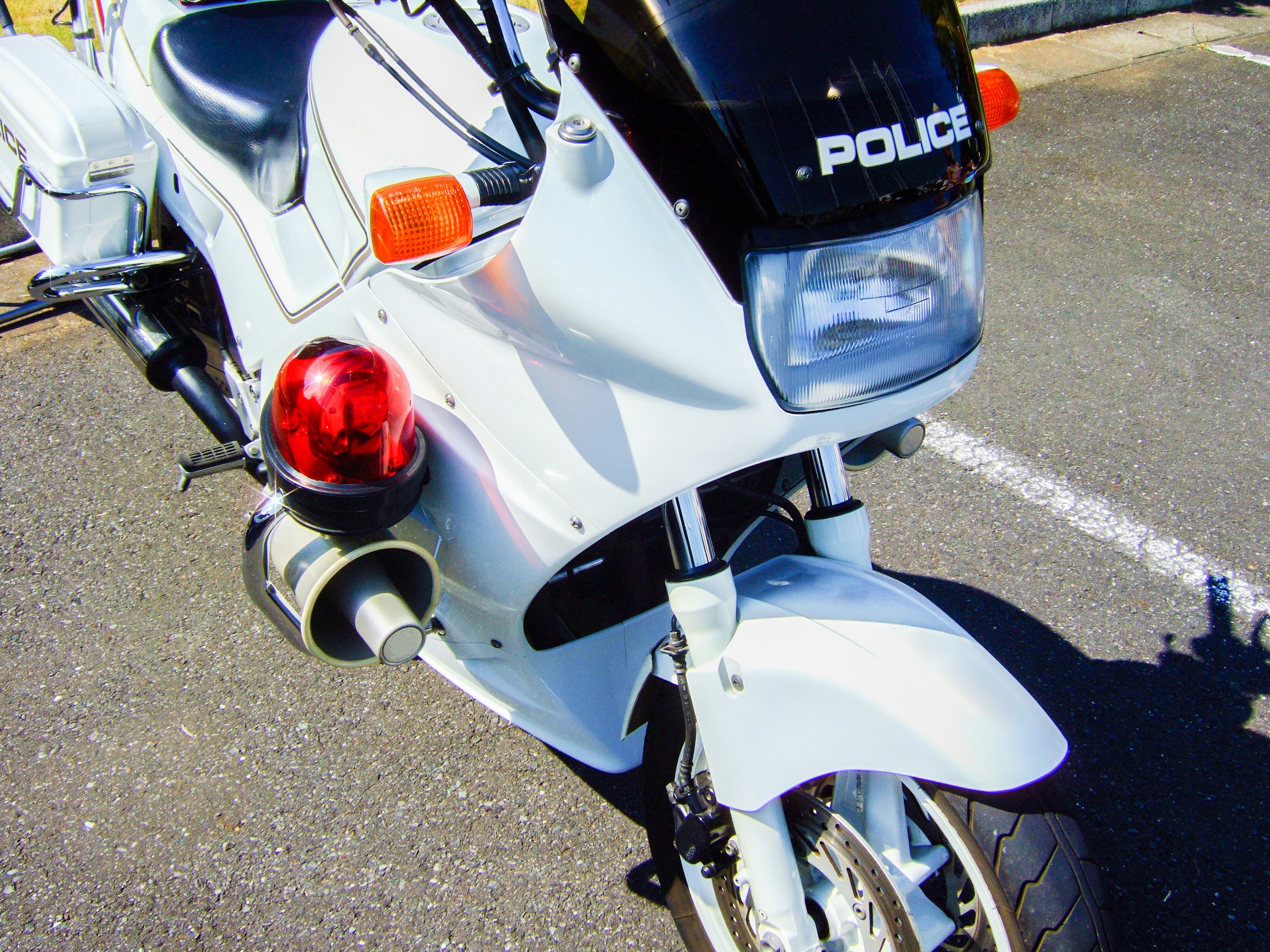 Image of a white police motorcycle featuring a distinctive front view