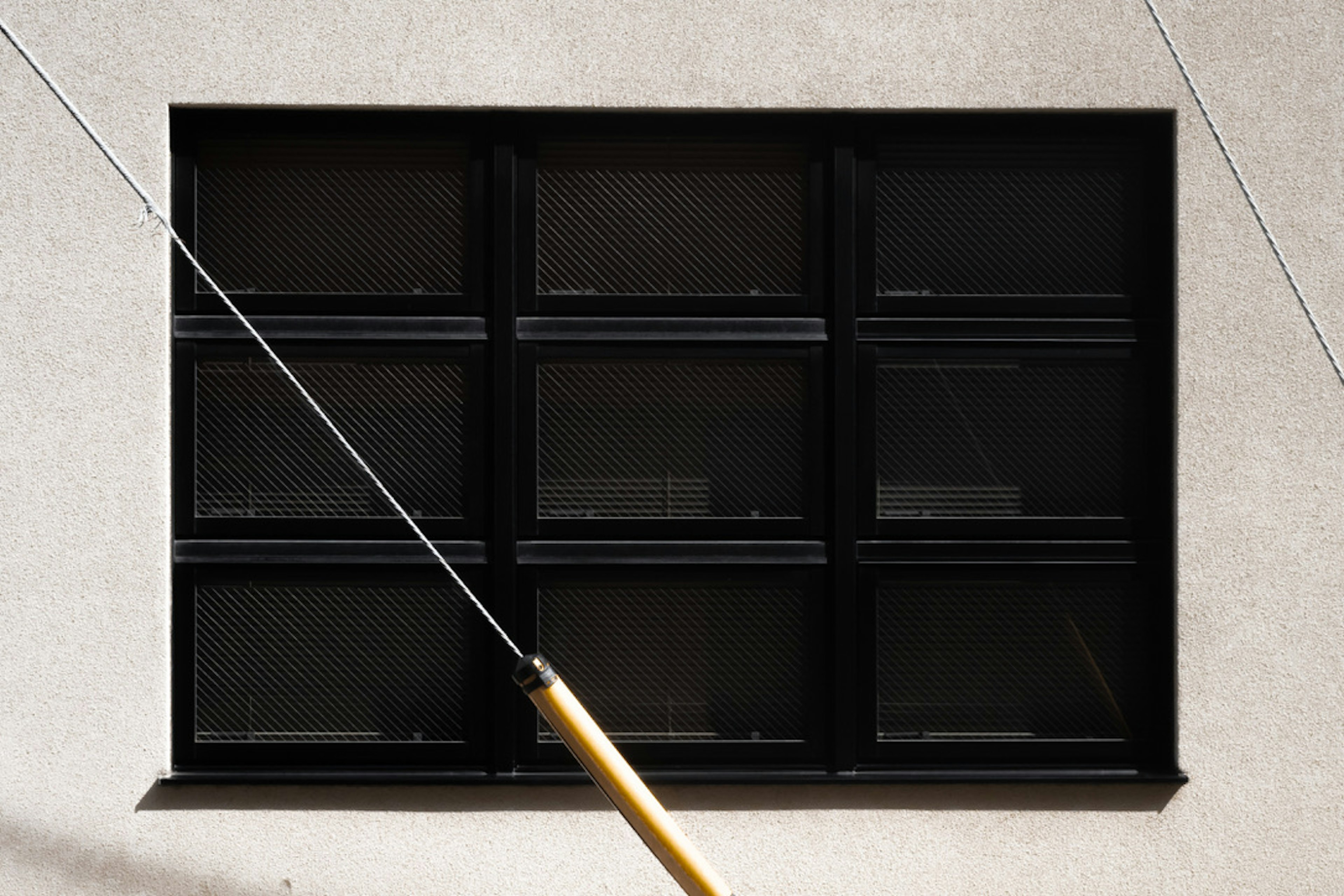 Exterior of a building featuring a grid of nine black framed windows