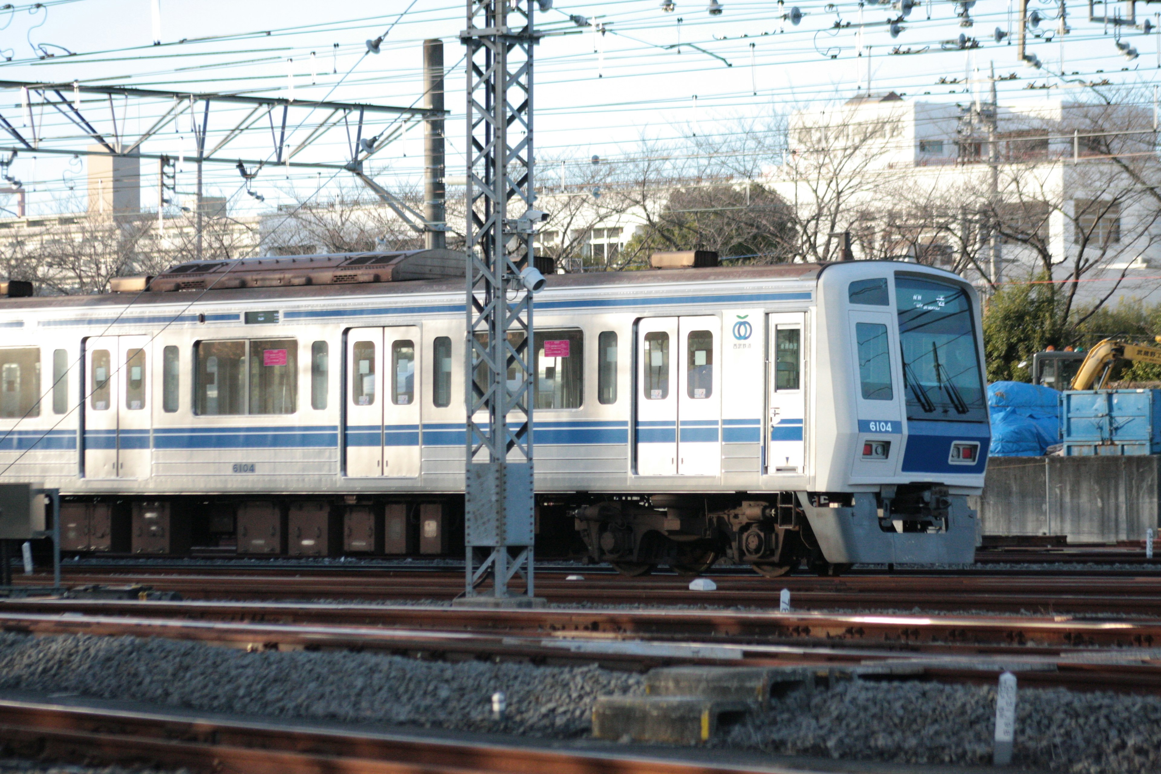 Blue train parked near railway tracks