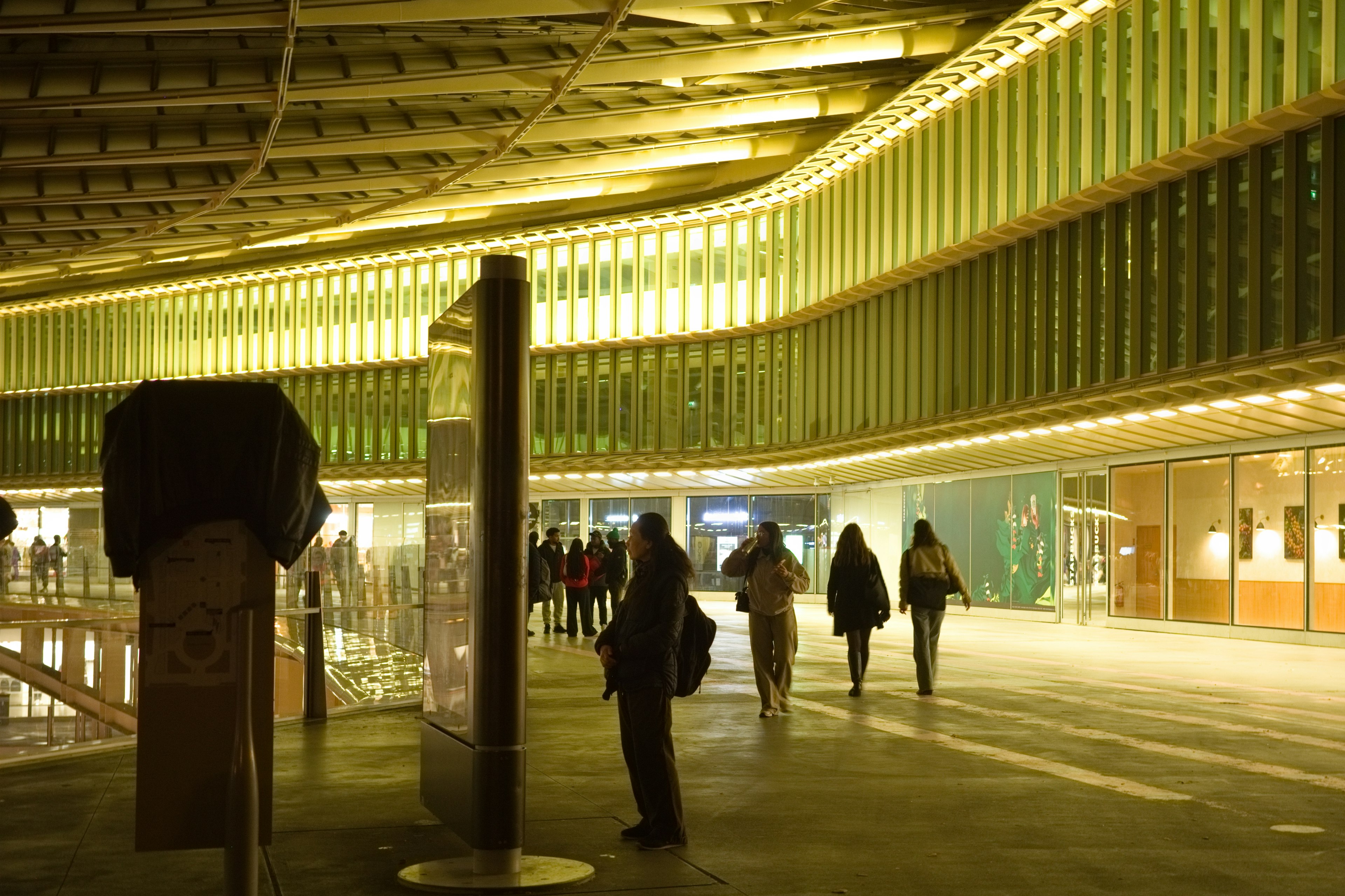 Spacious modern architecture with unique lighting and people walking