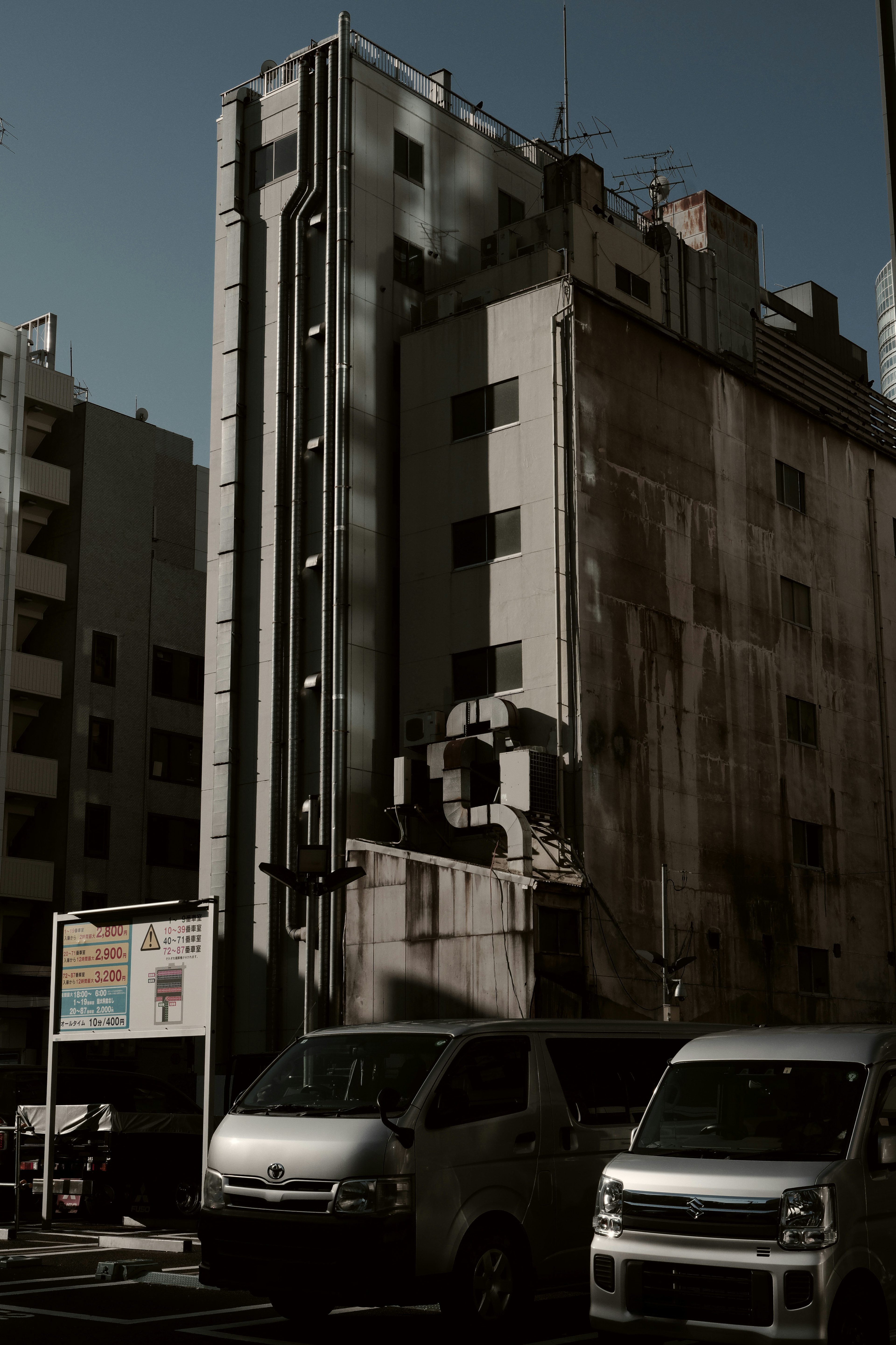 Paesaggio urbano con un edificio alto e auto parcheggiate