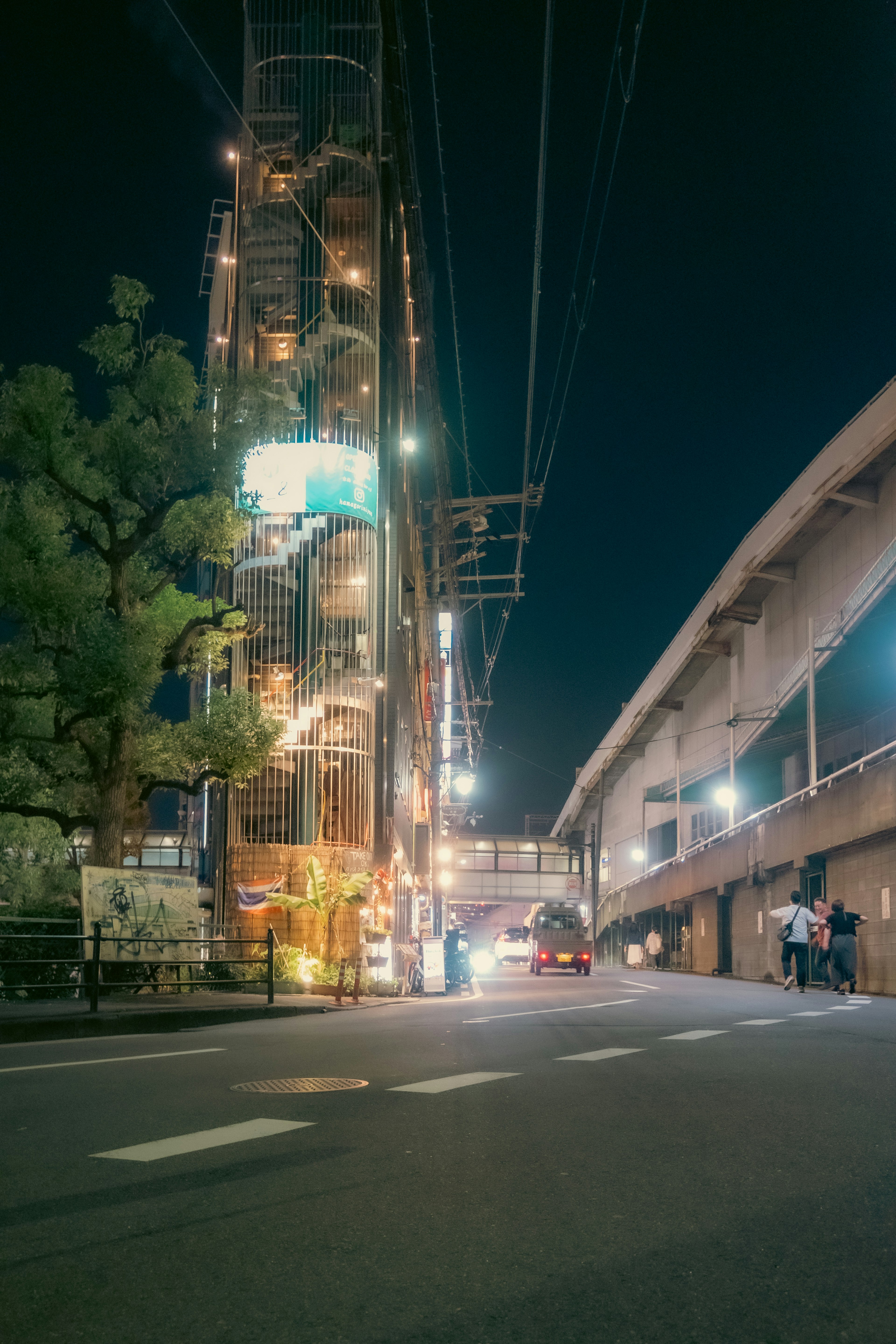 Urban landscape at night featuring a tall building and traffic