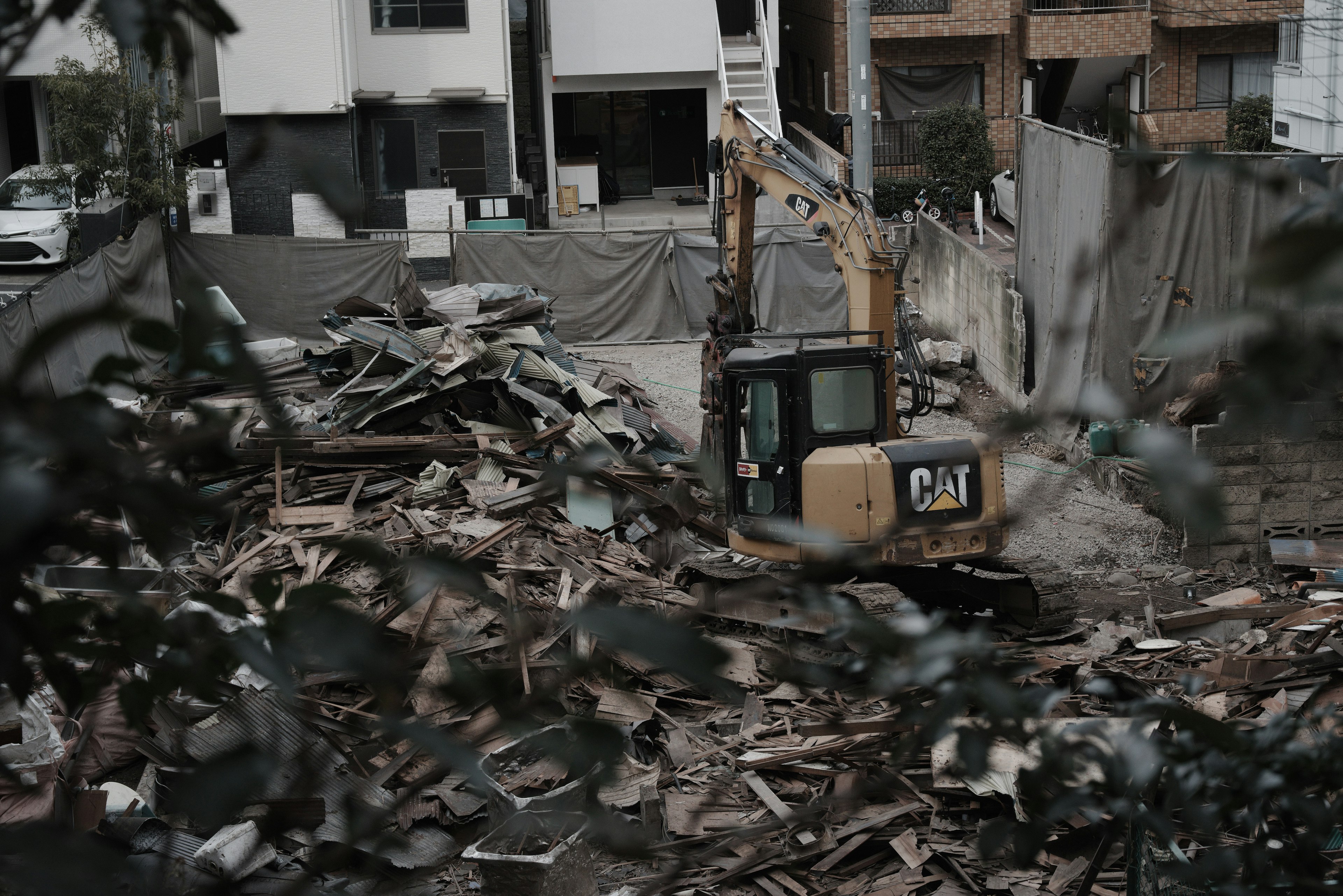 Construction site with heavy machinery working among debris