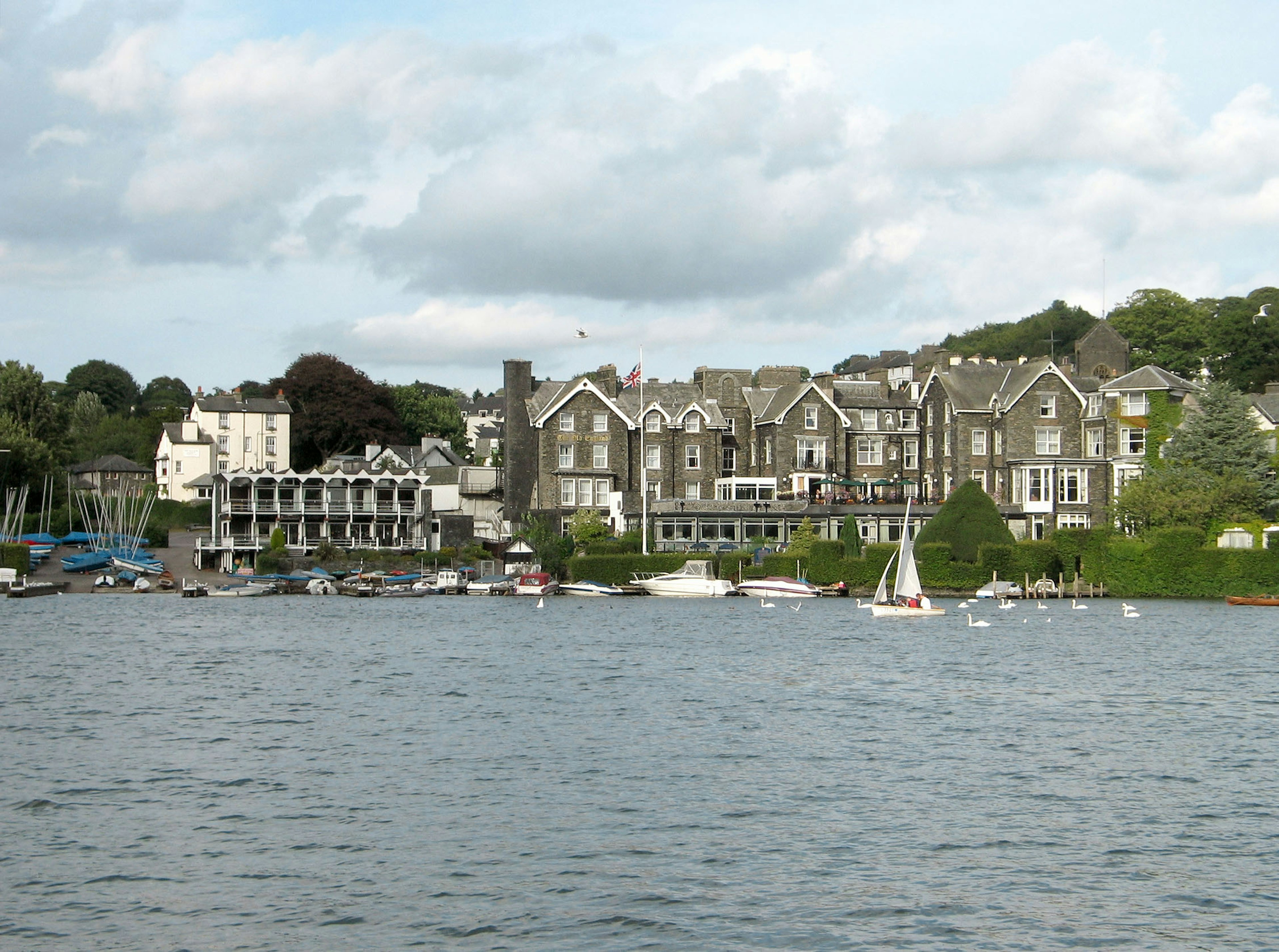 Scenic view of historic buildings by the lakeside with small boats