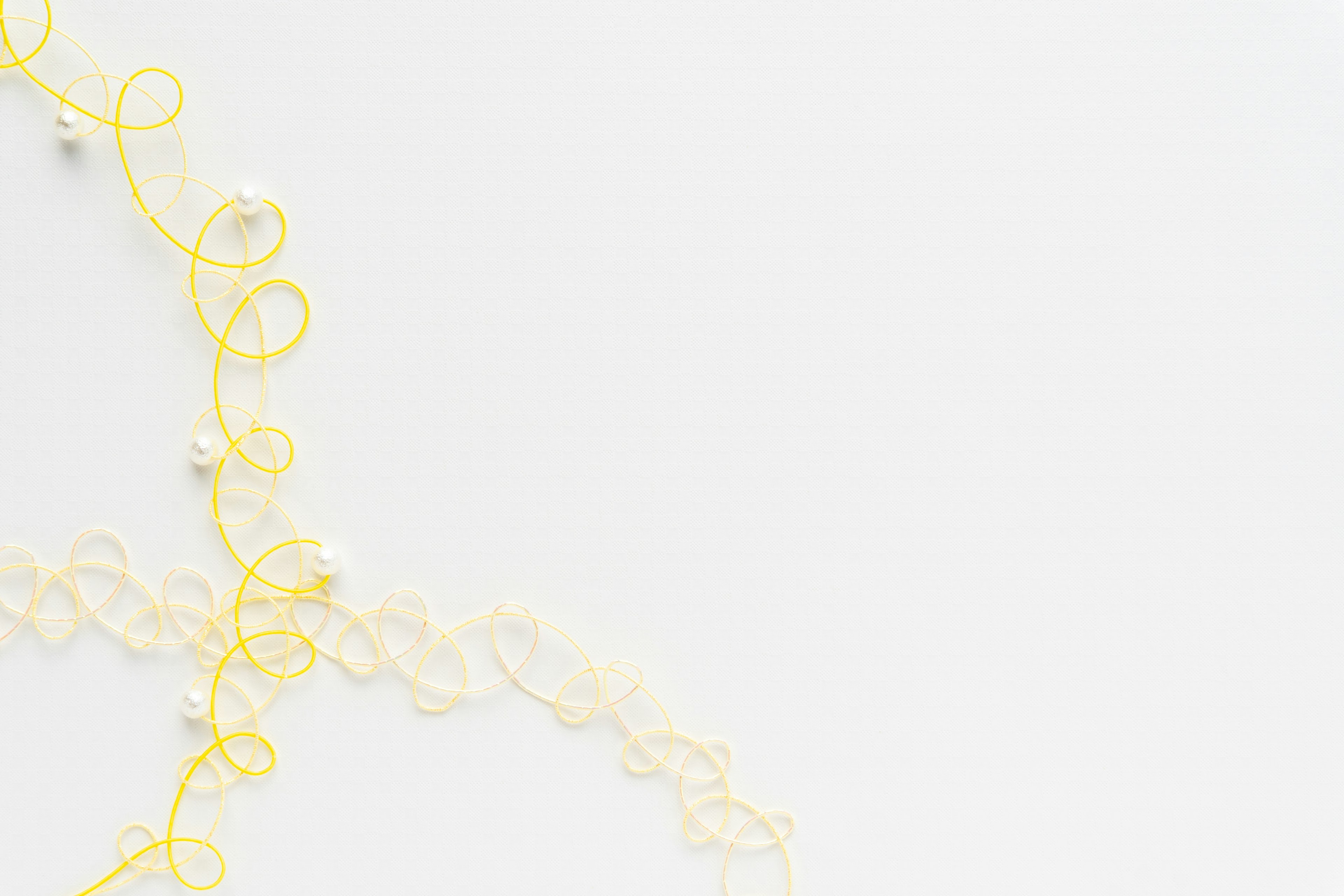 Delicate golden chain intertwined on a white background