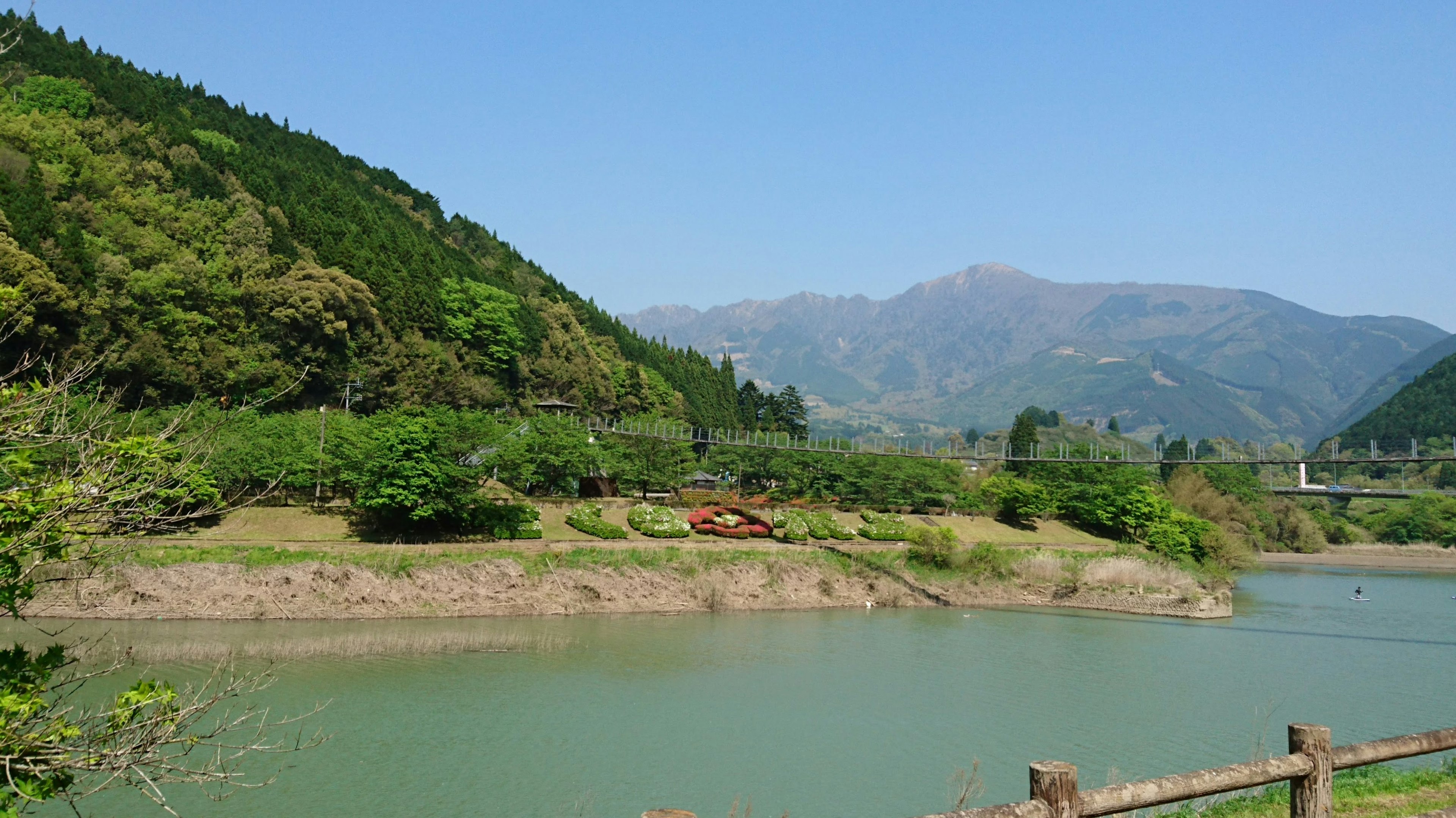 Scenic view of a river surrounded by green mountains