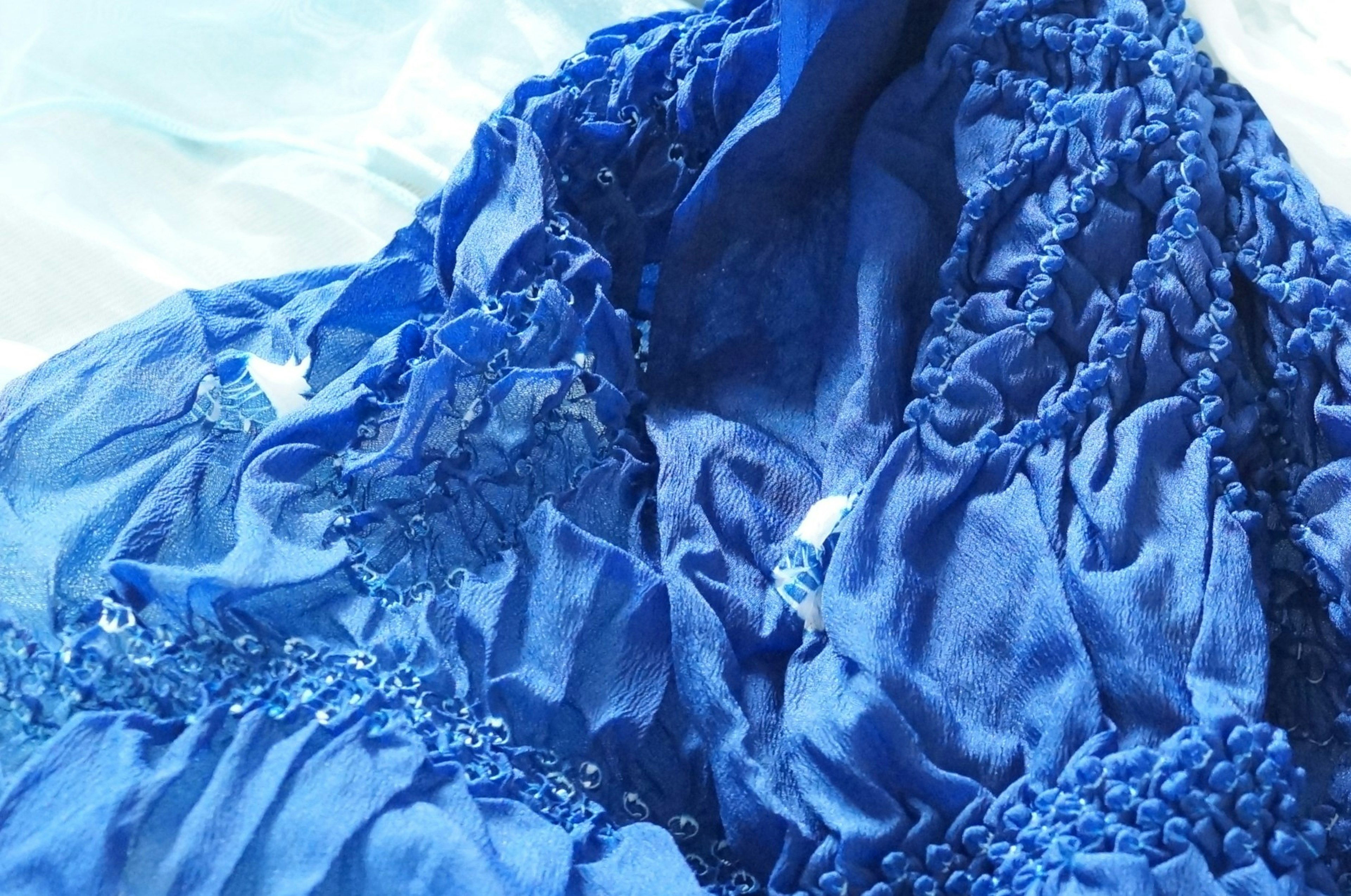 Close-up of a textured blue fabric draped elegantly